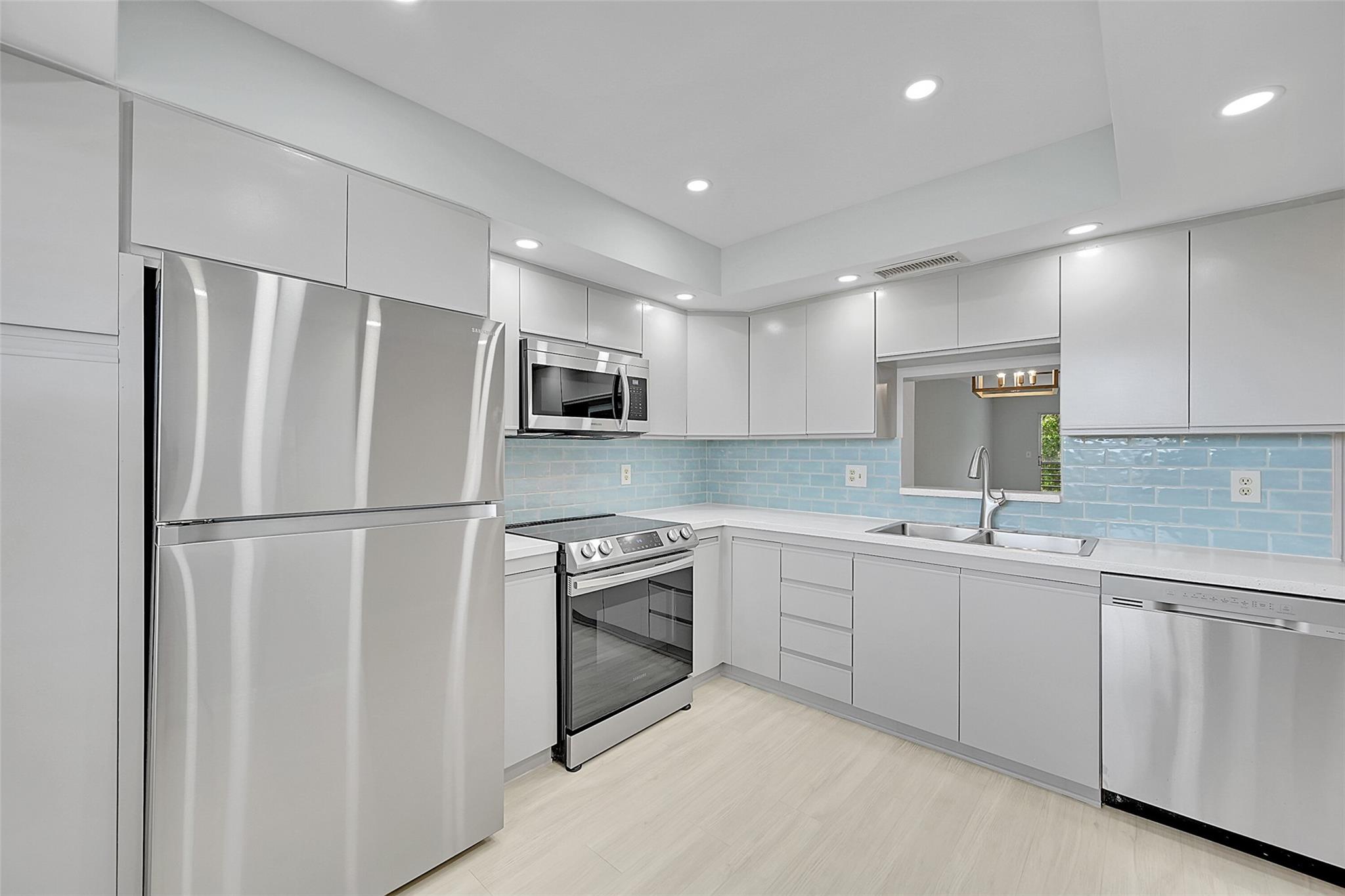 Beautifully renovated Deluxe model 2-bedroom, 2-bath condo with Washer/Dryer inside available for yearly rental! This spacious home features luxury vinyl flooring throughout, a modern kitchen with new appliances, and sleek updated countertops. Both bathrooms have been tastefully renovated with new showers and vanities, offering a fresh and contemporary feel. Enjoy serene views of the pool and landscaped garden from your private balcony. This well-maintained community offers comfort, convenience, and resort-style living. Perfect for those seeking style and relaxation. ASSOC REQUIRES 1 OCCUP 55+