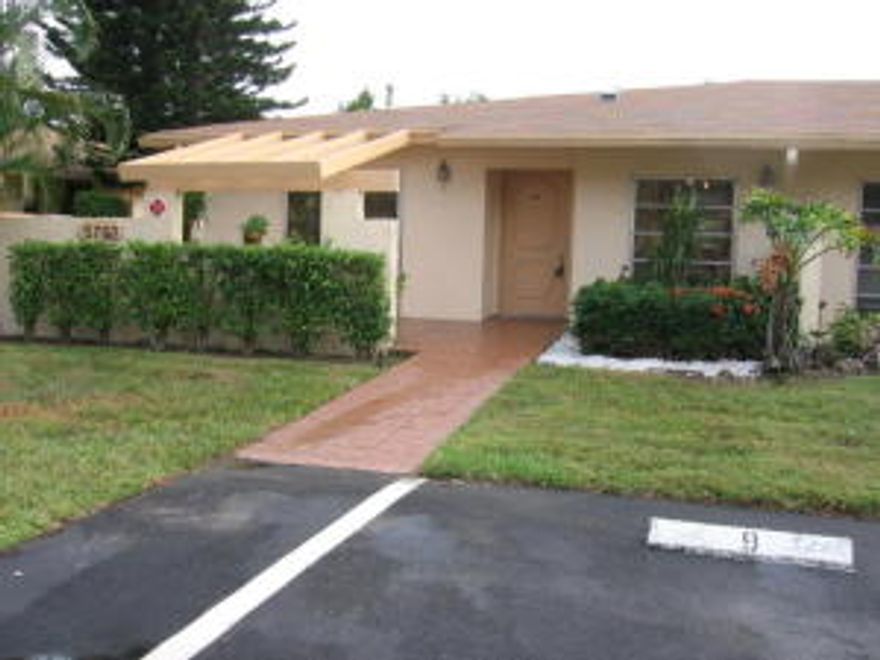 Beautifully renovated and updated villa! This is an end unit with a lovely view of the golf course! The eat-in kitchen features beautiful wood cabinetry, pantry, granite counters, awesome modern track lighting and all stainless steel appliances.  The refrigerator, dishwasher and microwave are all brand new! There is a stackable washer/dryer hidden behind pocket doors. Large stone look tile in a neutral color has been installed thru-out.  There is designer carpeting in both bedrooms. Both baths have wood vanities with granite counters and under mount sinks. The master bath has frameless shower doors. There is all new lighting and new ceiling fans everywhere. The master bedroom is oversized, and has a private cozy screened in patio with extra storage out back. There’s plenty of closet space here.  The living and dining room is large enough to add a desk area and still have plenty of seating. There is also another lovely patio out front.  Assigned and ample parking is right outside your door. The roof has recently been replaced and the outside is to be painted shortly. The clubhouse in this 55+ community has it all with a huge pool, spa, tennis, library, card room, arts and crafts, exercise room, cafÃ© and much more. There is golf of course with no mandatory membership. Or walk no further than your own satellite pool close by. This community is well maintained and conveniently located nearby to everything and has everything. Don't miss it.