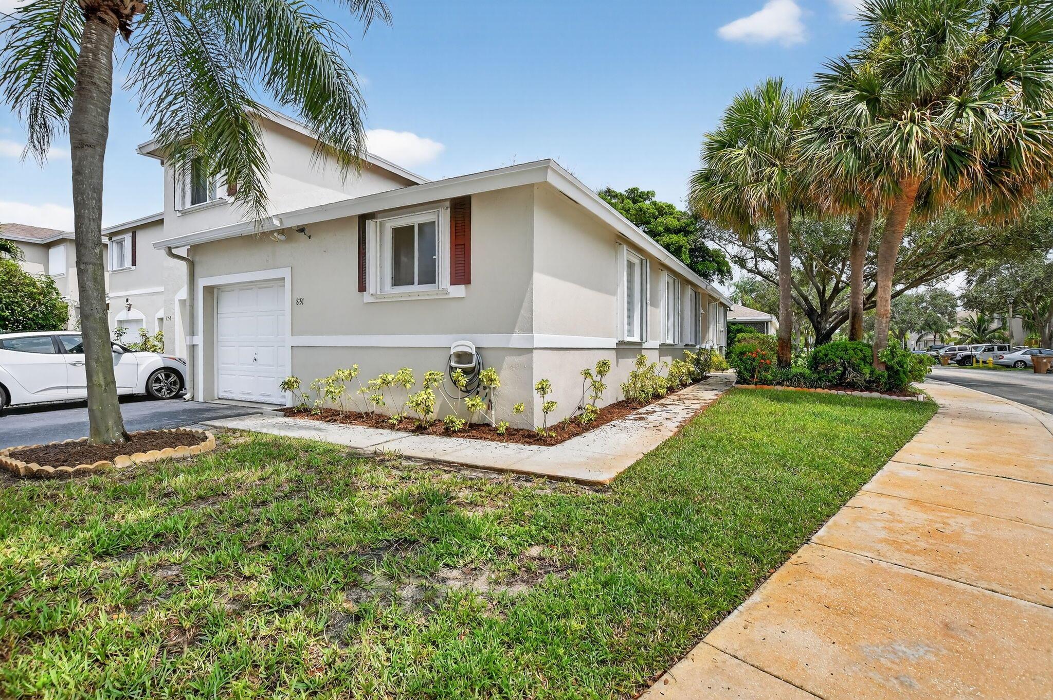 Completely Updated 2-Bed/2-Bath Corner Villa w/ 1-Car Garage!Move-in ready corner unit featuring vaulted ceilings and wood-look tile throughout. Updated kitchen with quartz waterfall counters, subway tile backsplash, stainless steel appliances, white cabinetry, and recessed lighting. Spacious open living & dining areas. Large primary suite with vaulted ceiling, walk-in closet, and remodeled bath with frameless shower & modern vanity. Generously sized 2nd bedroom with French door entry and adjacent updated full bath. Laundry/utility room inside. Screened patio, large side yard & backyard. Accordion shutters, newer roof, new blinds, fixtures, and fans throughout. Community offers pool and ample guest parking.