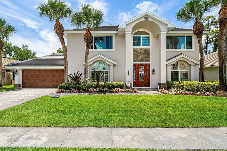 Discover the perfect blend of coastal luxury and modern peace of mind at 208 Longshore Drive, located in the highly desirable Shorewood Estates within The Shores. From the moment you arrive, the oak-lined sidewalks and mature trees set a tranquil tone, leading you up a slate and stack-stone walkway to striking solid wood double entry doors. Inside, the home unfolds with sophisticated wood-look tile throughout the main level, where a formal living room and a versatile dining or flex space offer ample room for both daily living and elegant entertaining. The heart of the home is a chef's dream, featuring updated custom grey cabinetry, a stunning waterfall quartzite countertop, and a matching backsplash, all complemented by premium stainless GE Profile appliances. All four bedrooms are tucked away on the second floor for maximum privacy, showcasing beautiful all-wood flooring and stylish window treatments. Beyond the aesthetic, this residence is engineered for ultimate resilience and comfort, boasting a brand-new 2025 whole-house generator supported by a 500-gallon propane tank, two brand-new 2025 AC units with all-new ductwork, a 2018 concrete tile roof, and full impact windows. Modern convenience is integrated throughout, with a wired-in WiFi booster, a comprehensive security system with Ring cameras, and smart-home controls for the pool, irrigation, and exterior uplighting.  The outdoor space is a true sanctuary, backing onto a lush, quiet preserve that ensures total privacy and silence. You can relax on the massive 60-foot covered patio or within the expansive screened lanai, which overlooks an oversized saltwater pool and a new 2024 remote-controlled heated jacuzzi. The fully fenced side yard provides an extra outside space, making this the ultimate retreat for unwinding with a glass of wine at the end of the day.  Situated in the heart of Jupiter, this property offers unparalleled access to A-rated schools and an active lifestyle where neighbors are frequently seen cycling or walking dogs through the shaded streets. You are just ten minutes from the pristine sands of Juno Beach and the dog-friendly beaches near the pier, and only minutes away from world-class golf, tennis, boating, and the vibrant dining scenes at Harbourside Place and Love Street. With PBI Airport just 25 minutes away, this home perfectly captures the sophisticated yet relaxed Jupiter lifestyle.