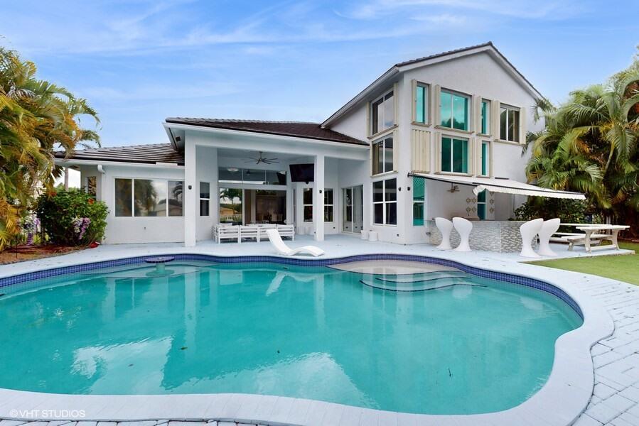Welcome to your dream home, a resort style gated community. This stunning 5 bedroom + theater, 4 full bathrooms 2-story pool home offers the perfect blend of luxury and convenience. New roof 2024, new AC 2025. New pool heater. New kitchen cabinets and appliances. Bosh coffee built in. Huge pantry. Outside professional kitchen, under 20 feet awning. Step outside and take advantage of the beautiful outdoor space overlooking the lake & with an inviting pool for those hot summer days. Large, covered patio area. A-rated Wellington schools, shops, restaurants, Wellington Mall and Equestrian facilities. Seller concession, or 2 by 1 down possible. Call if you want to know about this program.