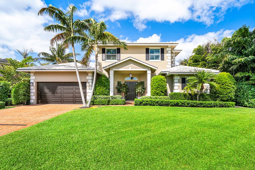 Located in the quaint seaside town of Ocean Ridge, this distinguished home built by Varga Homes in 2014, is located just two blocks from the beach. Designed for effortless coastal living, this home features volume ceilings and high-impact windows and doors, creating a light-filled, open interior. The first-floor primary suite offers custom built-out closets, a spa-inspired bath, and sliding glass doors that open to the pool. A separate private office provides a quiet and functional workspace. The chef's kitchen is appointed with Thermador appliances, custom wood cabinetry, and marble countertops,   effortlessly opens to the spacious family room.  Upstairs offers 3 bedrooms along with 2 full bathrooms and a loft.  A blend of marble and wood flooring enhances the home's refined yet relaxed  aesthetic throughout.  Outdoor living is equally impressive, featuring a covered loggia, a heated pool with sun shelf, summer kitchen, and a private turf backyard surrounded by lush tropical landscaping—ideal for entertaining or quiet retreat. Additional highlights include a whole-house generator, plantation shutters, and custom millwork throughout. Enjoy coastal living at its finest.  Only a short drive to Palm Beach Island and Delray Beach.