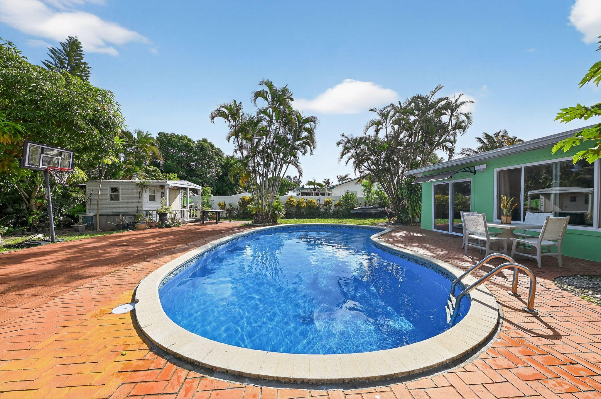 Welcome to this beautifully renovated and fully furnished 3-bedroom, 2-bathroom home for lease, nestled on a quiet cul-de-sac in Jupiter. Recently updated with a brand-new roof and fresh exterior paint (2024), this residence is move-in ready and designed for comfort and style. Inside, you'll find a bright and welcoming layout with hurricane-impact windows, elegant finishes, and thoughtful upgrades. The master bathroom features a travertine shower, while the second bathroom is accented with slate tile. A lovely Florida room provides the perfect spot to relax or entertain year-round. Outdoors, the lush backyard is a private retreat with a sparkling pool and ample space for entertaining under the Florida sun. The extended driveway offers plenty of parking, and