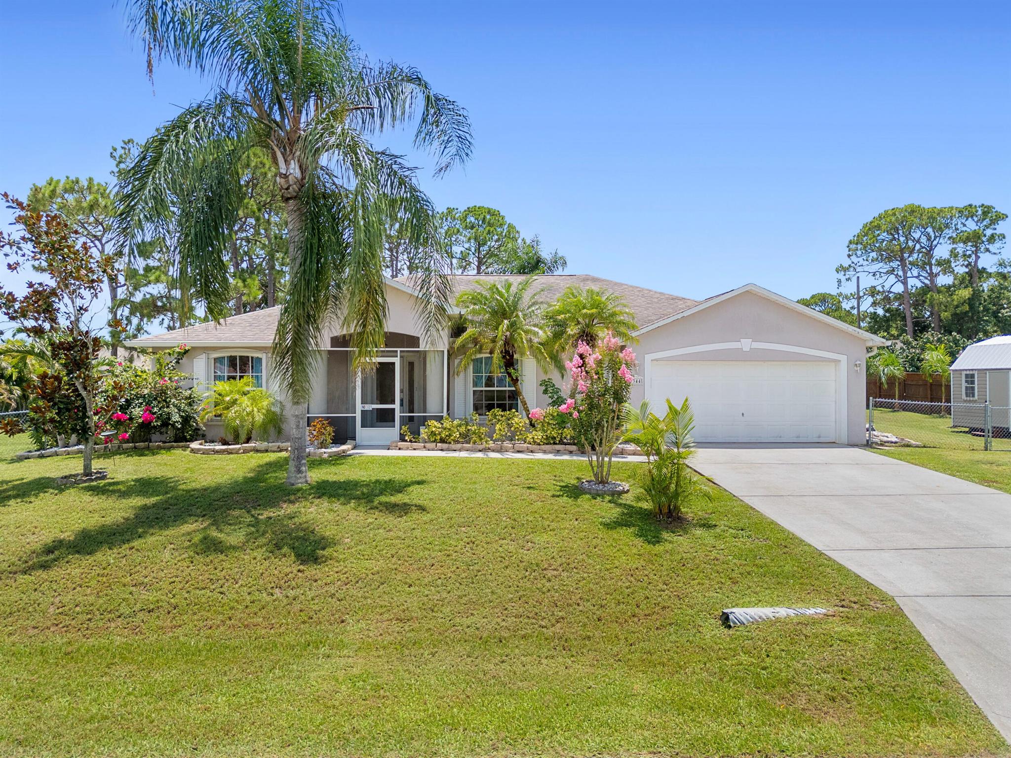 Located in a rapidly growing city just minutes from shopping, dining, and everyday conveniences, this stunning home offers the perfect blend of space, comfort, and style. Situated on a GENEROUS 0.69 ACRE LOT, there is plenty of room to park your RV, boat, or extra vehicles with ease. Inside, arched ceilings and fully tiled floors create a bright and open atmosphere. The beautifully upgraded granite kitchen features stainless steel appliances, a mosaic tile backsplash, and custom plant lighting. A formal dining room and living room provide elegant spaces for entertaining. Step outside to a LARGE ENCLOSED POOL, perfect for relaxing, hosting guests, or enjoying the Florida sunshine in complete privacy. The oversized owner's suite includes a walk-in closet, a soaking tub.