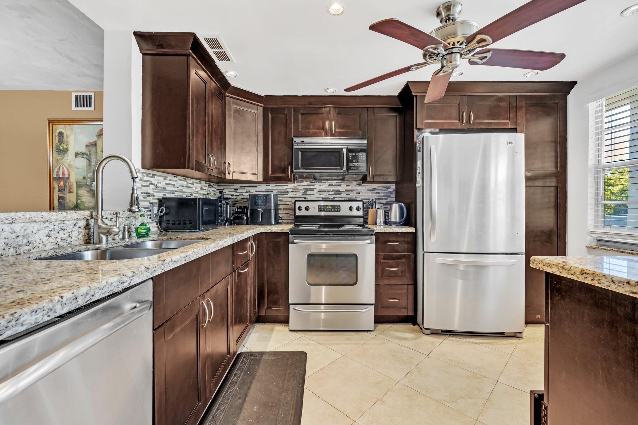 Updated and furnished 2 bed/2 bath unit. Open kitchen, shaker cabinets, granite countertops and stainless steel appliances. Primary room has a walk in closet and both full bathrooms feature upgraded cabinets/countertops, and walk in showers. Spacious tiled patio with windows, screens and roll down shutters. Wynmoor boasts a resort style living with a very active community. The amenities include: fitness center, golf, tennis, pickle ball, pools, clubhouse, billiard room, theater, restaurant, shows, recreational learning classes, shuttle buses, tree-lined walking/bike path, and much more. Assoc requires 15% down, 700 credit score & 1 occupant 55+. This is a 100% No Smoking building. No pets. No renting. Community Laundry area. Please ask your agent for the detailed financial requirement