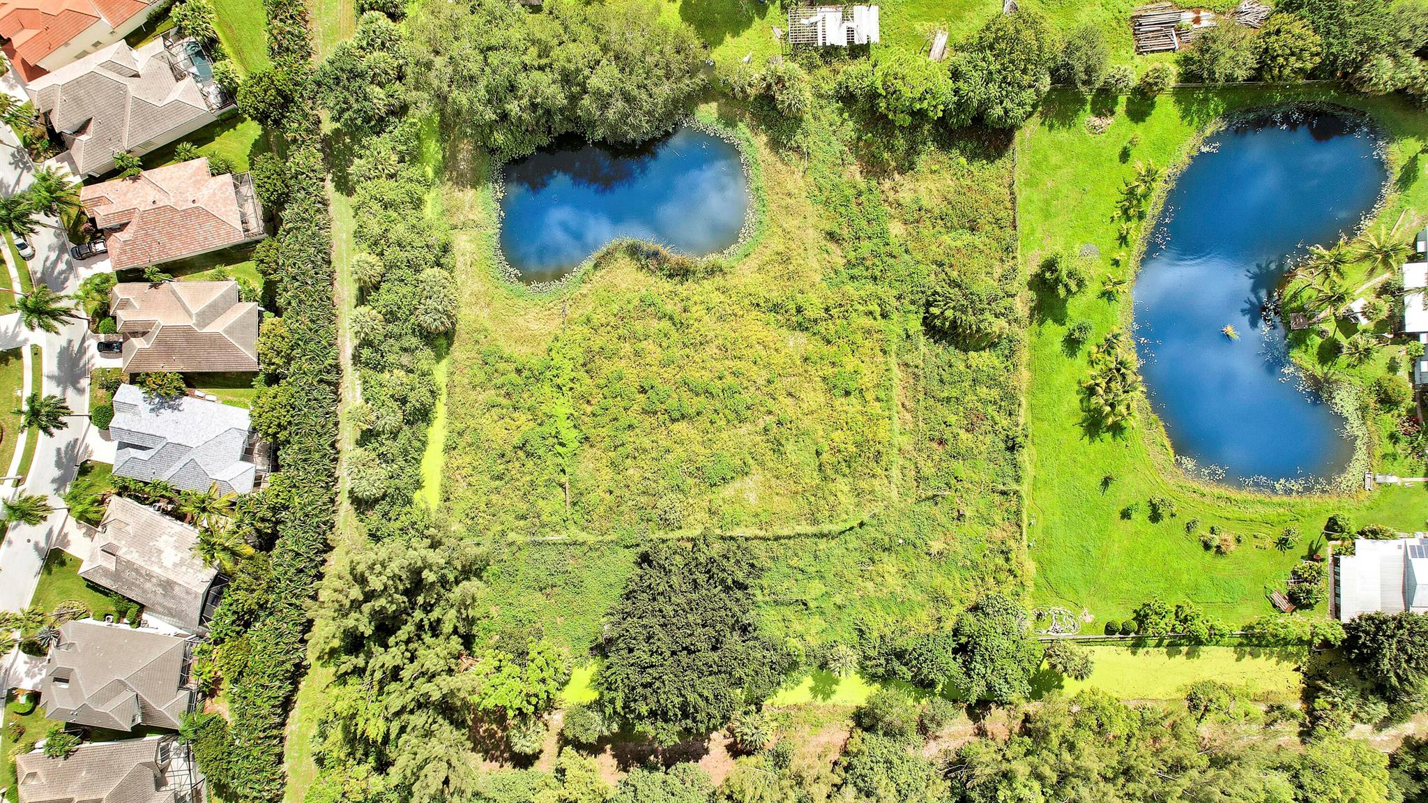 RARE LAND BANKING OPPORTUNITY IN PALM BEACH GARDENS! Secure an exceptionally scarce 2.5-acre parcel zoned for both Agriculture and Residential use. This unique property features a beautiful, tranquil pond and offers the space and privacy needed for a custom luxury estate or equestrian retreat. Strategically located immediately west of the prestigious Ibis community & directly across the street from the massive Avenir development, which will soon introduce millions of square feet of new retail, commercial, and residential growth. This is more than a lot; it's a true land banking asset offering unparalleled appreciation potential in one of South Florida's most explosive growth corridors. Don't miss this chance to invest in the future of Palm Beach Gardens.