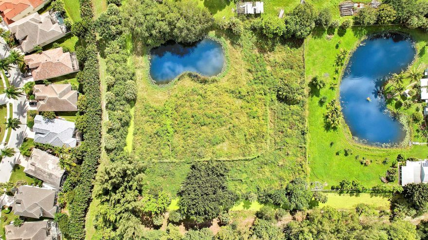 RARE LAND BANKING OPPORTUNITY IN PALM BEACH GARDENS! Secure an exceptionally scarce 2.5-acre parcel zoned for both Agriculture and Residential use. This unique property features a beautiful, tranquil pond and offers the space and privacy needed for a custom luxury estate or equestrian retreat. Strategically located immediately west of the prestigious Ibis community & directly across the street from the massive Avenir development, which will soon introduce millions of square feet of new retail, commercial, and residential growth. This is more than a lot; it's a true land banking asset offering unparalleled appreciation potential in one of South Florida's most explosive growth corridors. Don't miss this chance to invest in the future of Palm Beach Gardens.