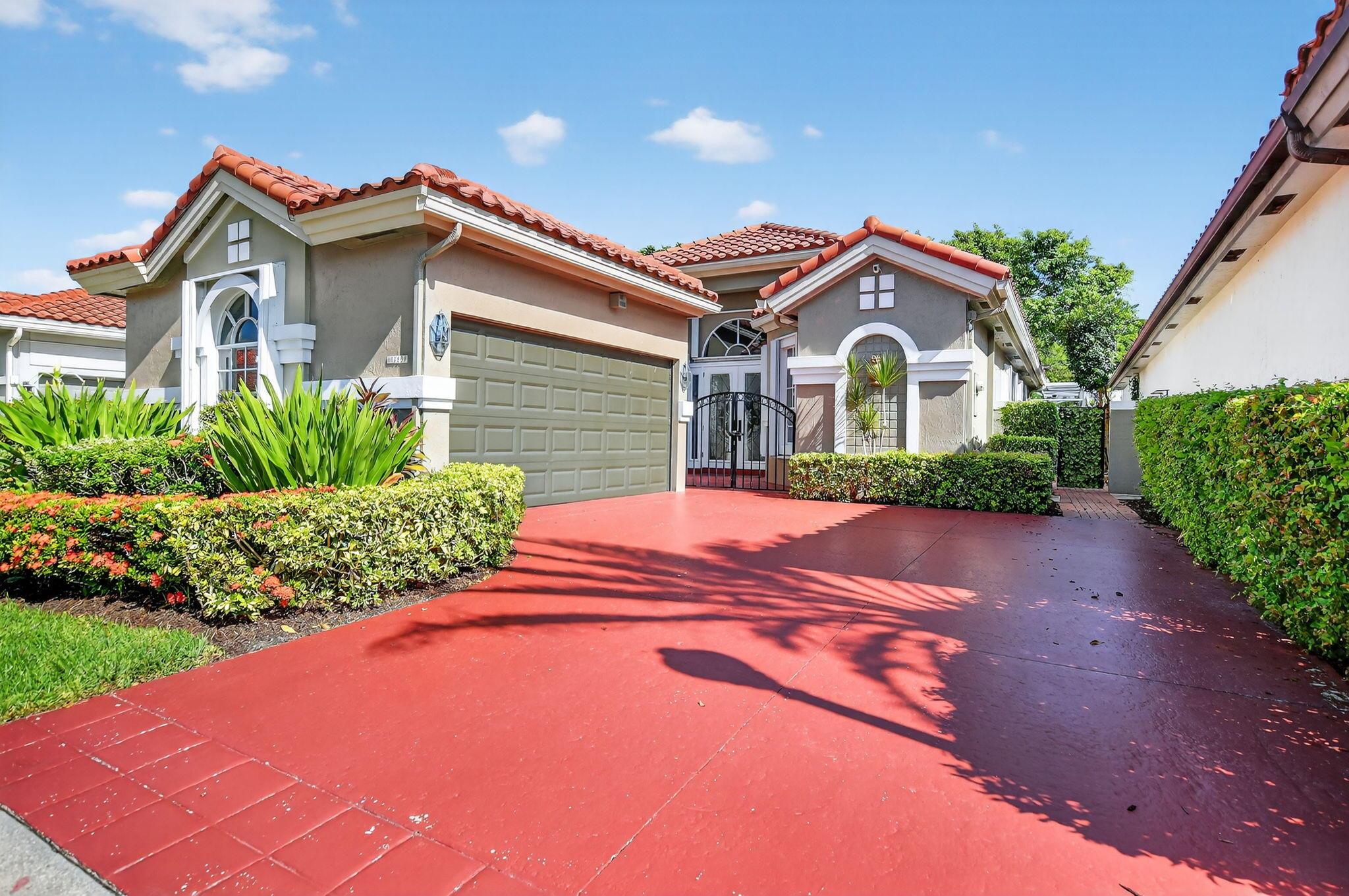 Discover your Florida oasis in this stunning 3BR/3BA home in Santa Barbara! A custom etched glass entry door with matching side panels sets the tone for a light-filled interior featuring vaulted ceilings, impact skylights, and an open layout. The living area impresses with a wave-style accent wall, complimented by stylish floating cabinets with a tile surface, white-wash laminate floors, and bamboo flooring in guest rooms. A private courtyard, spacious kitchen with updated appliances, and elegant design details make this home truly special. Additional features include a newer roof, 4-yr AC, accordion shutters, impact garage door and a screened heated pool. Enjoy resort style amenities--clubhouse, Olympic pool, jacuzzi, and tennis--just minutes from Town Center, dining, and A-rated schools!
