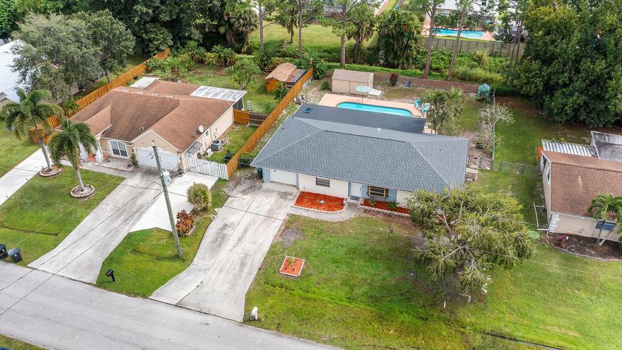 Beautifully remodeled pool home in the heart of Port St. Lucie. This stunning 3-bedroom, 2-bath residence perfectly combines modern design, timeless quality, and Florida's relaxed coastal lifestyle. The open layout showcases a fully remodeled kitchen with gleaming granite countertops, brand-new stainless-steel appliances, and expansive cabinetry providing abundant storage. Both bathrooms are elegantly updated, and the brand-new roof (October 2025) offers lasting confidence and peace of mind. The expansive screened porch—one of the largest layouts of its kind—flows seamlessly to a large in-ground pool and outdoor kitchen with sink and waterline, ready for a fridge or icemaker. AC 2019 WH 2020. Ideally located near pristine beaches, Clover Park, Tradition Square, and the Botanical Gardens.