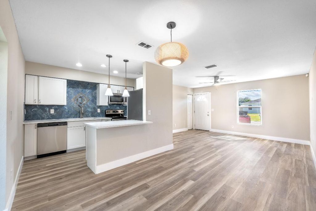 Photo of 1133 SW Sudder Avenue, Port Saint Lucie, FL 34953 (MLS # R10933321)