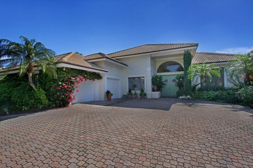This elegant golf course residence is designed for Florida living.  The double-door entry opens to the sunken living area with a soaring coquina stone fireplace and slate tile floor.  A custom built-in entertainment and bar unit completes this lovely and livable space.  The formal dining room is punctuated with a columned entry. The adjacent kitchen includes a large breakfast bar and ample bay window area ideal for casual dining.  Together, the kitchen and adjacent family room create a seamless great room. All living areas open to the spacious lanai which provides al fresco space both under roof and outside the screen room.  A hot tub is located within the screened area, while the sparkling swimming pool awaits outside surrounded by lush vegetation.