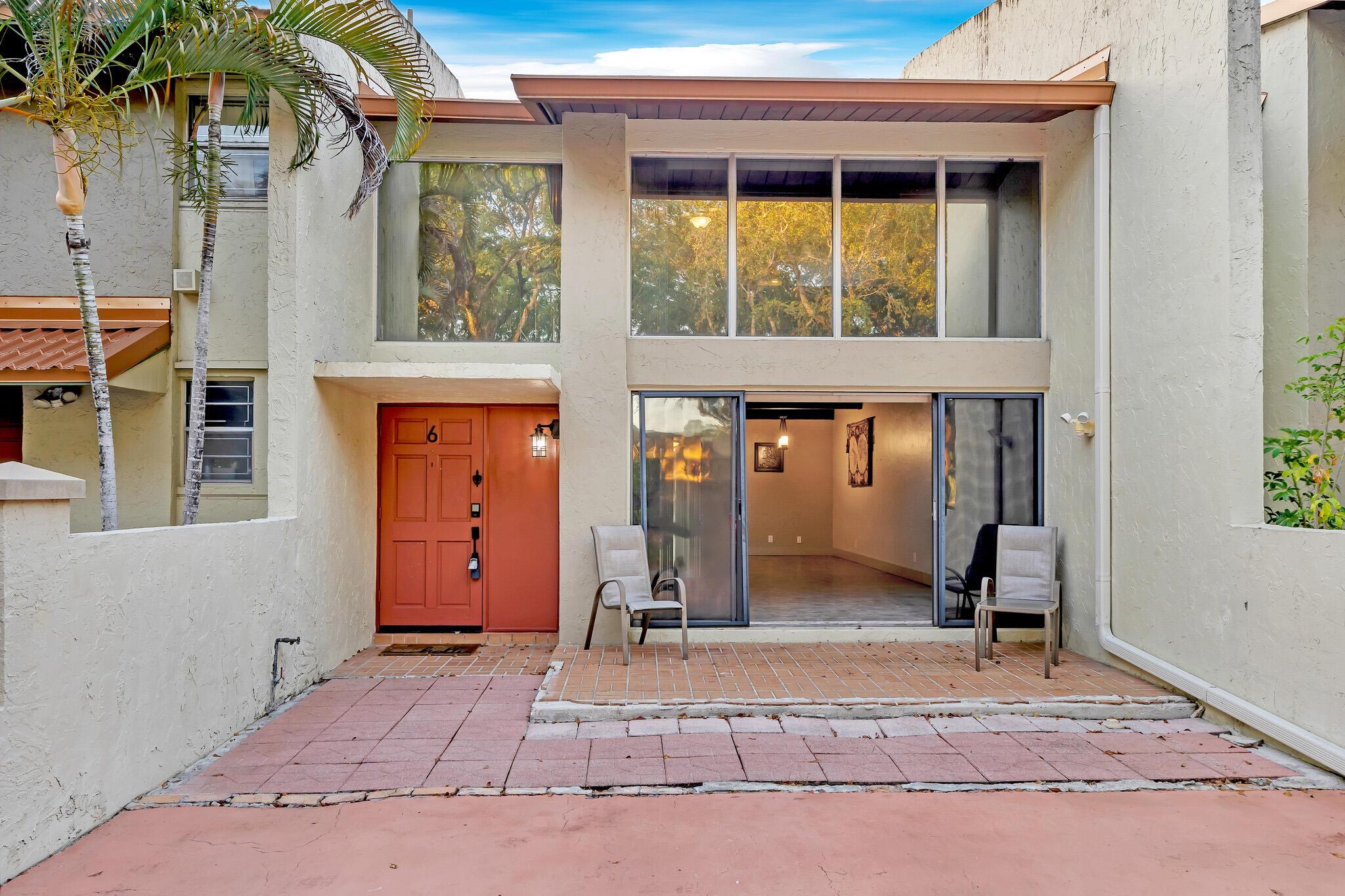 Spacious and updated villa-style condo, 2-story 2-bedroom 2-bath plus loft, in Majestic View, a quiet and exclusive community on Jacaranda Golf Club in Plantation. Home features open concept chef's kitchen with quartz counters, custom backsplash, bar seating, and stainless steel appliances; tile throughout; stunning wood and beam vaulted ceilings; walls of sliders with UV protective film, framing golf course views; main BR suite with balcony and walk-in closet; bedrooms and baths on both floors; washer and dryer in unit; new roof; large patio; and private driveway for two vehicles. Exterior to be painted this year, and golf course landscaping refresh is in progress. Close to shopping, restaurants, parks, highways and FLL airport. Community features lush tropical trees and plantings,