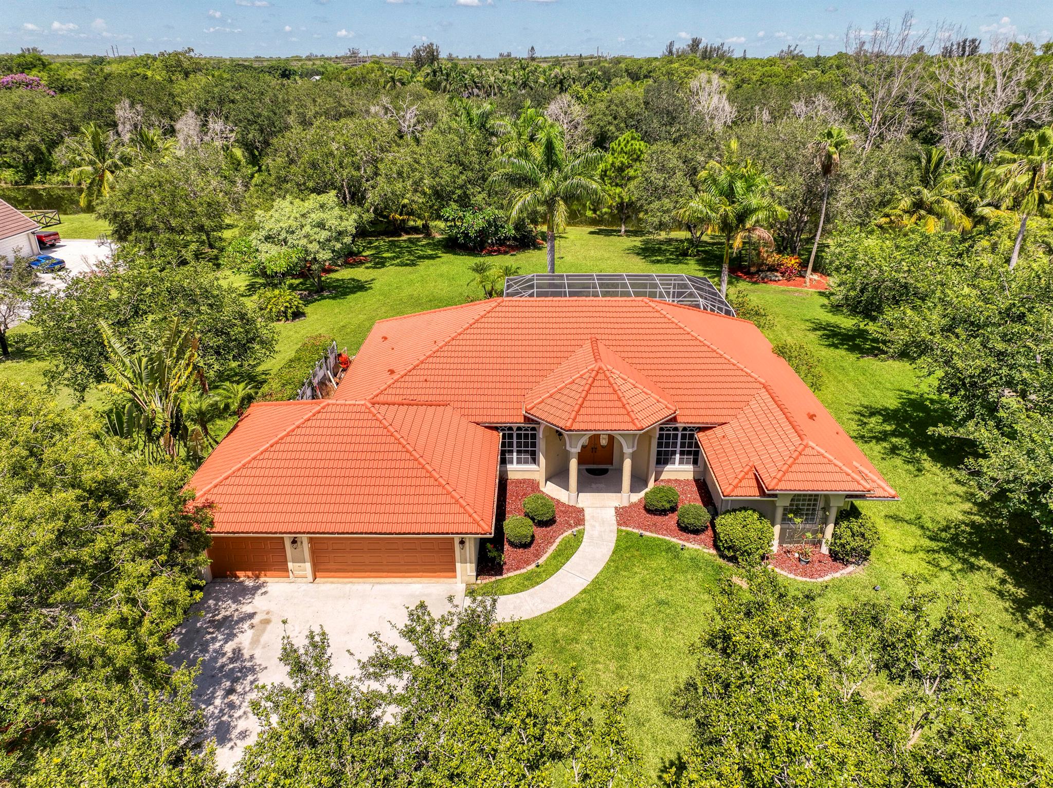 Welcome to this stunning single-family home located west of 441 and Lantana Road in beautiful Lake Worth! This spacious residence features 4 bedrooms, 2.5 bathrooms, and a 3-car garage, offering comfort and convenience for your family. Enjoy your own private oasis with a sparkling pool and a screened patio, perfect for entertaining or relaxing. The home is surrounded by gorgeous landscaping and boasts an amazing lake view, providing peaceful and picturesque surroundings.Inside, you'll find generous living spaces filled with natural light, a modern kitchen, and ample storage. Don't miss this exceptional opportunity to own a well-maintained home in a prime location, schedule your private showing today.