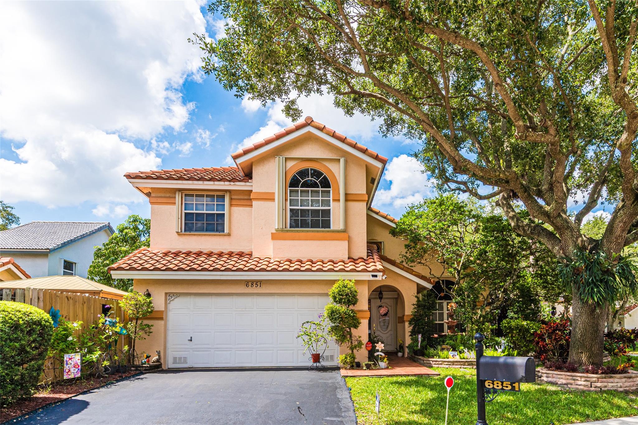 Welcome to your dream Home! Set on a corner lot with over 8,000 sq ft of fenced outdoor space, this home is a paradise for kids, pets, and guests. Step into a very well taken care home where you will experience the inviting foyer entrance, separate living, dining rooms. Open kitchen, countertop eating, Stainless Steel Appliances, breakfast area and adjacent family room. Vaulted ceilings, Tile & Wood panel flooring., separate laundry room, Modern designer-style bathrooms, custom closets shelving, extra cabinets and shelving in garage. Hurricane shutters protection, Spacious covered screened patio, with metal roof. Roof and A/C updated in 2018, low HOA monthly maintenance. Close to Shopping, Retail Stores, High School and more. Don't let this gem in Margate, FL, slip through your fingers.