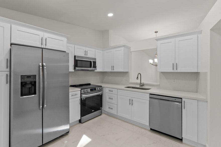 Welcome to your new oasis in the highly sought-after community of Whisper Walk. This stunning residence has been meticulously renovated from top to bottom, offering timeless style with modern comfort.Step into your chef's kitchen, beautifully appointed with LG stainless-steel appliances, quartz countertops, and designer-grade soft-close cabinetry. Enjoy casual mornings in the charming breakfast nook.The oversized living and dining area is perfect for relaxation or entertaining, showcasing elegantly crafted marble flooring throughout.  Retreat to the bedrooms where you'll find luxury flooring, thoughtfully designed layouts, and spa-inspired modern bathrooms. Unwind with a cup of coffee or a glass of wine on the air-conditioned patio overlooking lush, green garden views—your personal sanctuary. Just steps away, enjoy all Whisper Walk has to offer. Take a leisurely stroll to the community's exceptional amenities and embrace an active, vibrant lifestyle. This is more than a home—this is the lifestyle you've been waiting