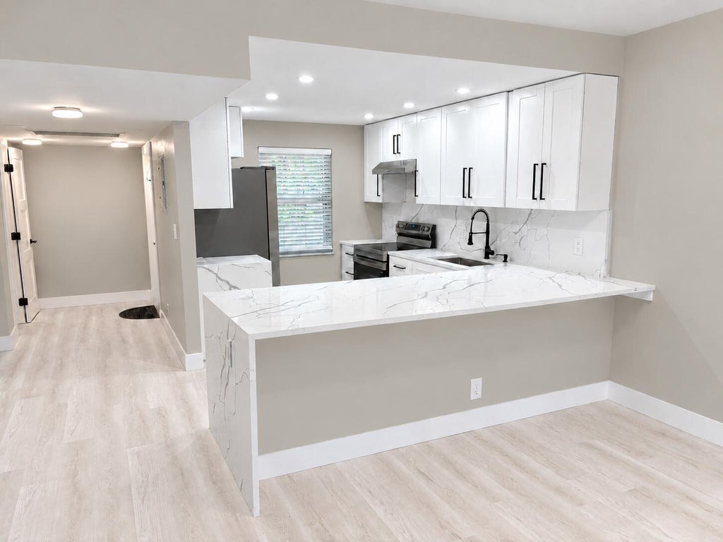 Photo of 3900 Oaks Clubhouse Drive #101, Pompano Beach, FL 33069 (MLS # B26087998)