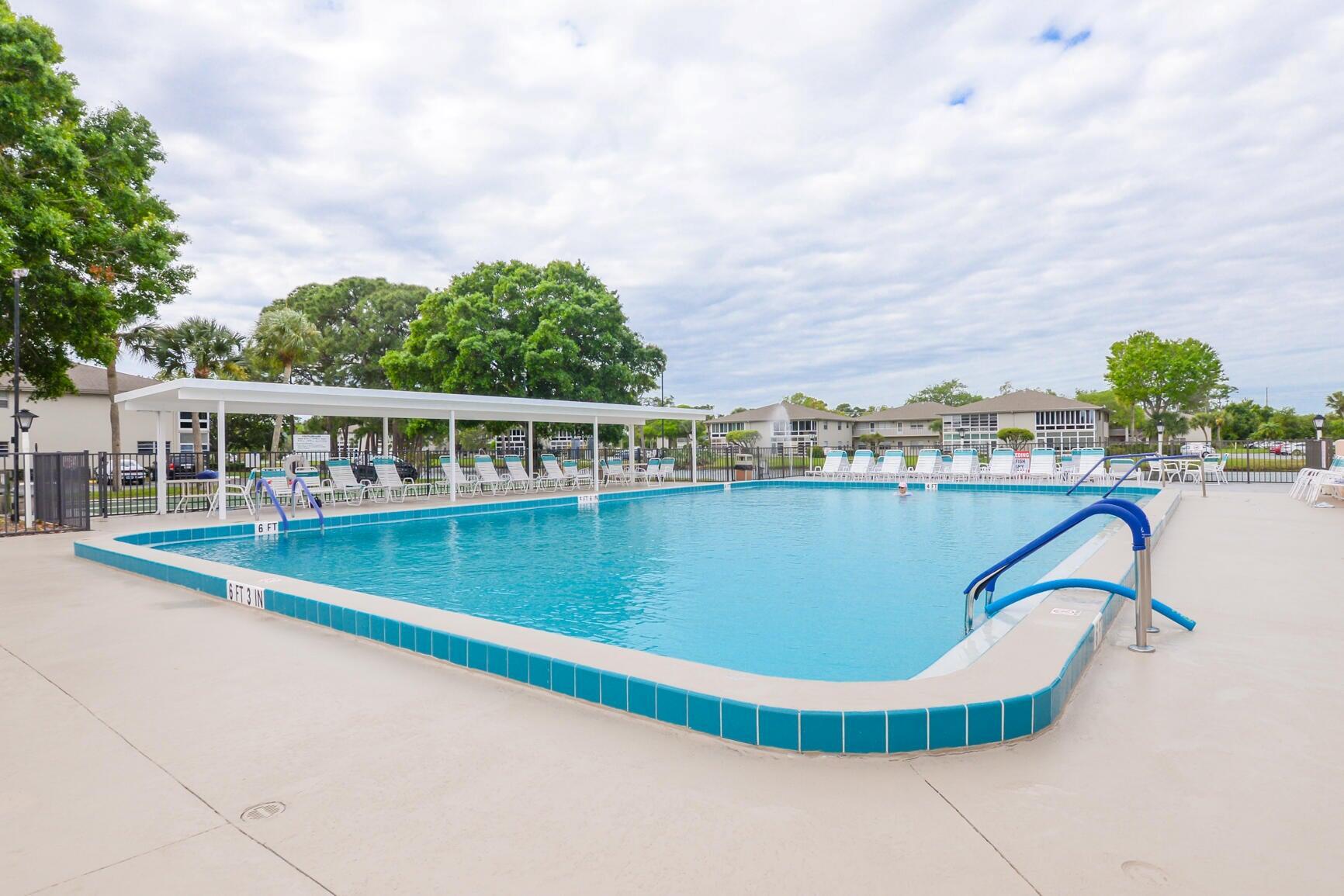 Welcome home to this beachy and bright, 2/2 concrete block condo with lovely lake view from your private lanai. Move in ready and completely furnished with adorable tropical flare and many upgrades. Vinyl plank flooring throughout, water heater (2022), refrigerator(2023), AC (2013), new paint, bathroom vanity, toilet and vinyl plank in Lanai area. Affordable living with cable, internet, water, sewer, building maintenance, insurance and onsite manager all included. NO CITY TAXES. Vista Saint Lucie is an active 55+ community with plenty of activities to enjoy including tennis, fitness room, pool, hot tub, shuffleboard, billiards, arts, crafts, barbecues, Bingo, classes, parties & more. Close to beaches, grocery, pharmacy, hospital, fishing, highways & more.