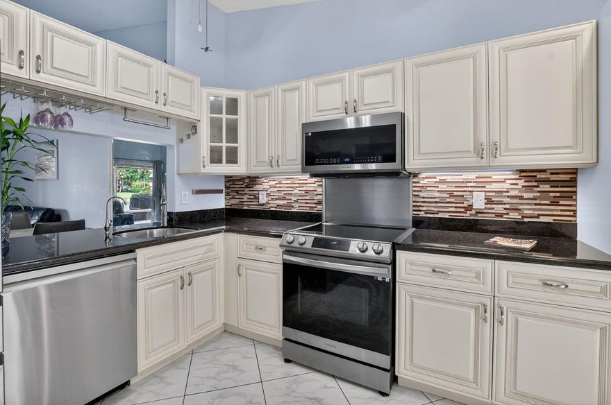 Owner has reduced the price by $12,000 to encourage offers-Motivated sellers for this beautifully remodeled 2 bedroom/ 2 bathroom waterfront villa located in the heart of BOCA RATON, offering stunning long lake views and an open, airy layout with vaulted ceilings. This move-in ready  home features a fully updated kitchen with stainless steel appliances, modern finishes and a seamless flow into the dining room and living rom-perfect for both relaxing and entertaining. Enjoy indoor-outdoor living with two patios: one open air and one enclosed overlooking the tranquil lake. The spacious primary bedroom suite also overlooking the lake includes large walk-in closet and beautifully remodeled en-suite bathroom. Additional highlights include a FULL HOME GENERATOR  for peace of mind, also a second bedroom with a completely remodeled bathroom, interior laundry room, tankless hot water heater. Residents enjoy resort style amenities including 2 community pools, tennis courts, clubhouse, hot tubs, sauna, game room, billiards, and even pickle ball being played. Located in a gated community, all ages too with an exceptionally low HOA that covers exterior insurance, roof maintenance, cable, water, sewer, trash removal, pest control and gated security. This centrally located villa offers the perfect combination of comfort, convenience, and waterfront living.