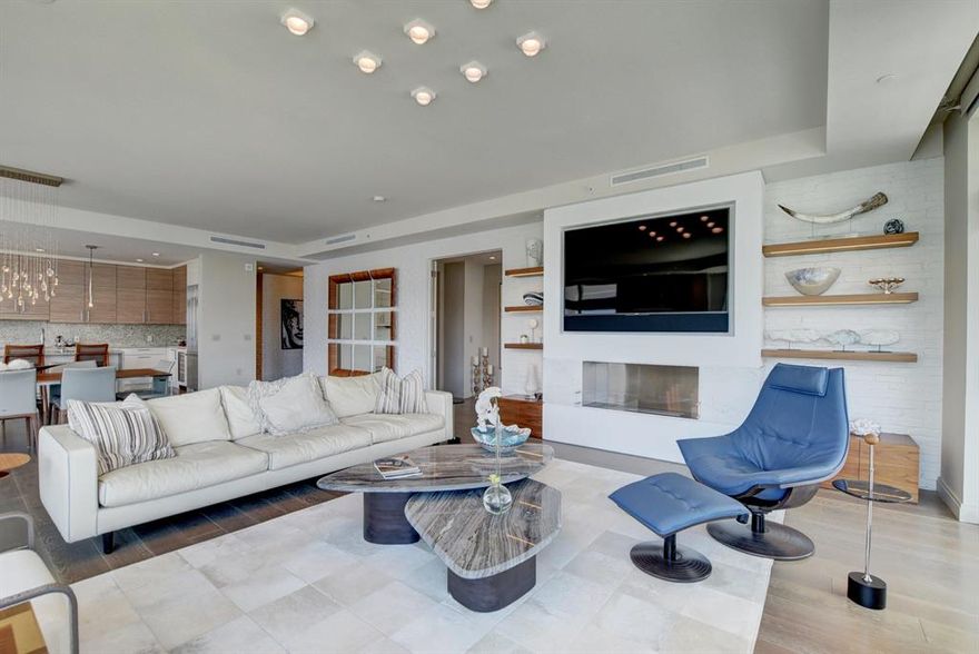 This beautiful sixth floor home showcases both ocean and Intracoastal views. For secluded entry, elevator opens directly into  private foyer, where you will be met with white brick clad walls and gorgeous double glass doors.The custom Chicago brick wall has been brought into the living room where a designer wall unit and fireplace become a stunning focal point. On the opposing wall a custom bar provides perfect balance. Glass walls and sliders throughout flood the living space with natural sunlight accentuated by a Southern exposure. The open floor plan has been designed for a gracious indoor/outdoor lifestyle. Chef's kitchen fully equipped with Bosch appliances, Nolte cabinetry and quartz waterfall island.Primary bedroom boasts ocean view with custom woodwork wall creating a soporific