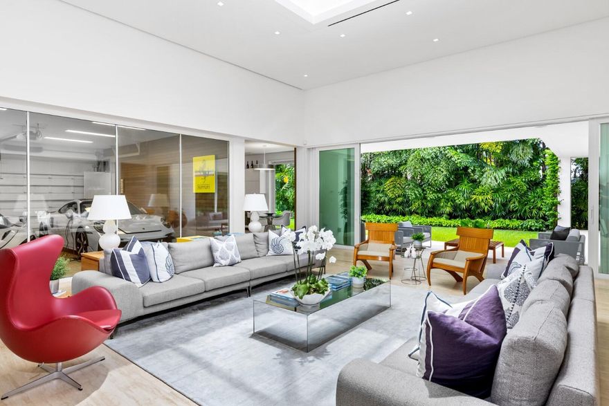 Stunning, custom contemporary home designed by award-winning architect Daniel Kahan of Smith and Moore Architecture. This home is an auto-enthusiasts dream property! This pristine 3 bedroom + den, 3.2 bathroom home is situated on a fantastic south side Sea Street lot in the center of town. Features fabulous 4-car garage and automobile showroom. Light filled formal living room with dramatic skylight overlooks the showroom with retractable blinds. Eat-in kitchen with expansive island, top-of-the-line appliances, walk-in pantry, and breakfast room. Beautiful primary suite with walk-in closet and primary bath with dual sinks and oversized shower. Expansive covered loggia and meticulously maintained grounds. No detail has been overlooked with pristine finishes and gorgeous marble and hardwood