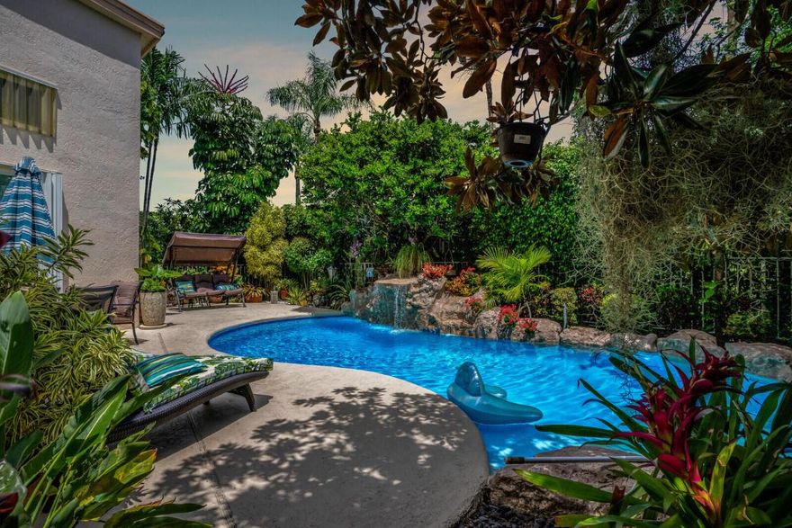 You will fall in love with this beautiful tropical paradise. When you approach the home there is gorgeous landscaping creating beauty & privacy. Upon entering the home, you will notice the spacious foyer & the vaulted ceilings with crown molding. You will be pleased to find the large kitchen nicely updated with an island & new cabinetry. Opposite the kitchen is a lovely family room. The tile floors are neutral newer & appealing. The house is light & bright! The formal living room & dining room are nicely appointed & a great size. The yard is to die for! Tons of entertaining space overlooking the spectacular pool area. There is additional land behind the pool area where you will find some great fruit trees. This property has a Newer a/c & electric panel. Quite corner location. Please come view this gorgeous home in Evian at Indian Spring!