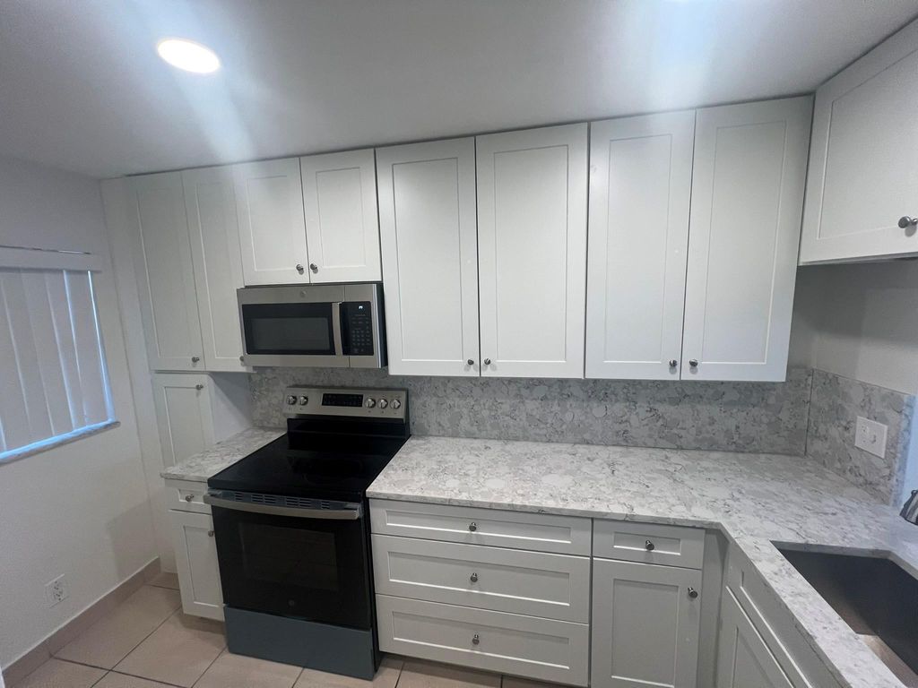 Photo of 9430 Poinciana Pl #415, Davie, FL 33324 (MLS # F10543421)