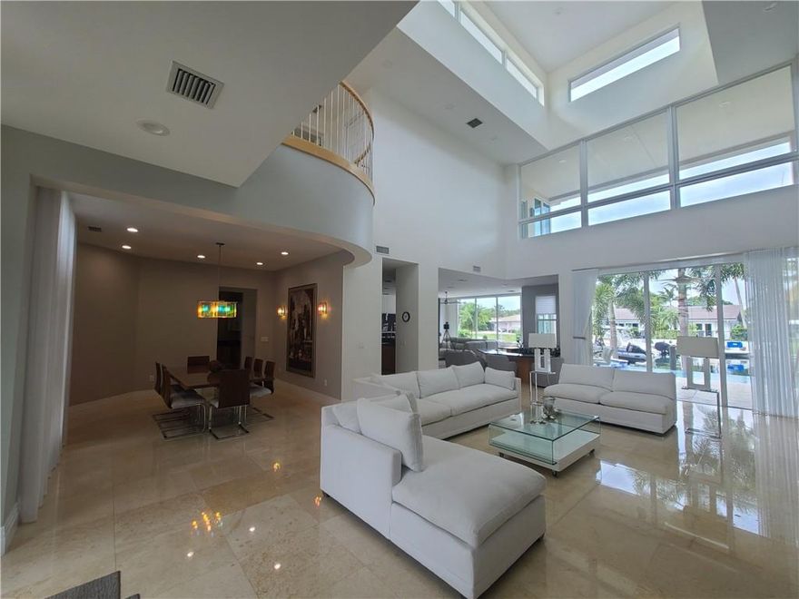 Exquisitely unique. The sleek understated entrance gives no hint to the beauty you experience once you enter! This transitional contemporary home unites elegant sophistication & comfortable harmonious living! From its superb location on short cut de sac street only minutes from Hillsboro Inlet by H20 to its flowing floor plan, every detail has been attended to. Huge gourmet kitchen w/breakfast area opens to family room & full bar w/seating overlooking infinity edge pool, spa & water. Full outdoor kitchen. Relax & enjoy in 1st floor theatre room. Butler's pantry. Master suite is it's own living area w/fireplace, morning bar, full seating area, TV! Beautiful master bath, 2 shower heads, 4 body sprays. Each bedroom has large balcony & en-suite bath. 1st & 2nd floor laundry. 12k# lb boat lift.