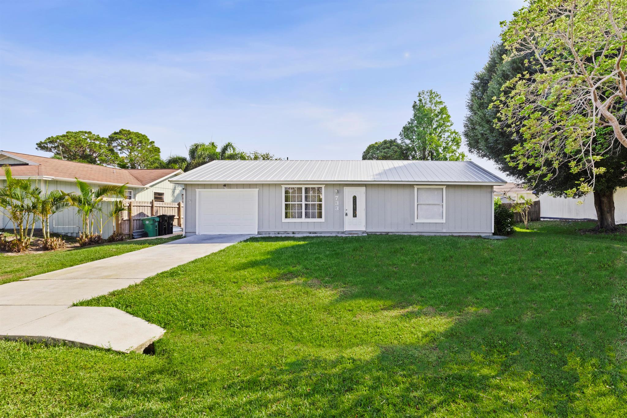 Welcome home to this charming 2-bedroom, 2-bathroom residence with a 1-car garage, located in the heart of Port St. Lucie. Featuring a brand new roof, this move-in-ready home offers an open floor plan with beautiful laminate flooring throughout. The updated kitchen boasts granite countertops, a center island, and stainless steel appliances--perfect for everyday living and entertaining. The spacious primary suite includes a walk-in closet and an updated bathroom. Enjoy the outdoors on the screened-in patio overlooking a large backyard with plenty of room to personalize. Ideal for first-time buyers or as a smart investment opportunity.