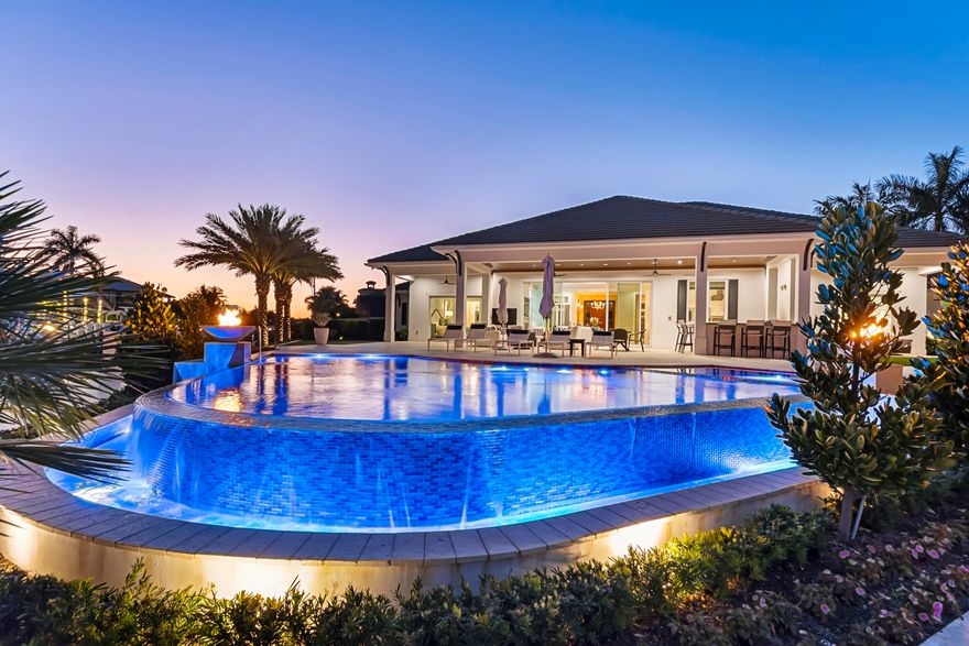 THIS SPECTACULAR BRITISH WEST INDIES-INSPIRED ESTATE IS PERFECTLY POSITIONED ON A RARE SOUTH FACING POINT LOT, OFFERING AN EXTRAORDINARY 246 FT OF SEAWALL FRONTAGE AND BREATHTAKING WATER VIEWS FROM EVERY ANGLE. DESIGNED FOR BOTH GRAND ENTERTAINING AND RELAXED COASTAL LIVING, THIS ONE STORY MASTERPIECE SHOWCASES IMPECCABLE CRAFTSMANSHIP AND THE FINEST MATERIALS THROUGHOUT.  FEATURING FOUR SPACIOUS BEDROOMS, FOUR AND A HALF BATHS, AND A PRIVATE OFFICE. THE THOUGHTFULLY DESIGNED SPLIT-BEDROOM FLOOR PLAN ENSURES COMFORT AND PRIVACY.  THE CHEF'S KITCHEN FLOWS SEAMLESSLY INTO THE EPANSIVE OPEN LIVING AREAS, CREATING A IDEAL SETTING. STEP OUTSIDE TO YOUR PRIVATE RESORT STYLE OASIS. THE OVERSIZED BACKYARD PATIO WITH A STUNNING INFINITY EDGE POOL, SPA & FIRE FEAUTURES. ENJOY THE GENEROUS OUTDOOR ENTERTAING SPACES WHICH INCLUDES A SUMMER KITCHEN AND PUTTING GREEN.  THIS RESIDENCE IS EQUIPPED WITH PREMIUM SMART HOME FEATURES INCLUDING A LUTRON LIGHTING CONTROL SYSTEM, WHOLE HOUSE SOUND WITH SURROUND SOUND, REMOTE SECURITY CAMERAS, AND A WHOLE HOUSE GENERATOR FOR ULTIMATE PEACE OF MIND.  IDEALLY LOCATED JUST MINUTES FROM THE VIBRANT SHOPS AND DINING OF ATLANTIC AVENUE AND THE PRISTINE SHORES OF DELRAY BEACH. THIS EXCEPTIONAL PROPERTY OFFERS THE VERY BEST OF LUXURY WATERFRONT LIVING.