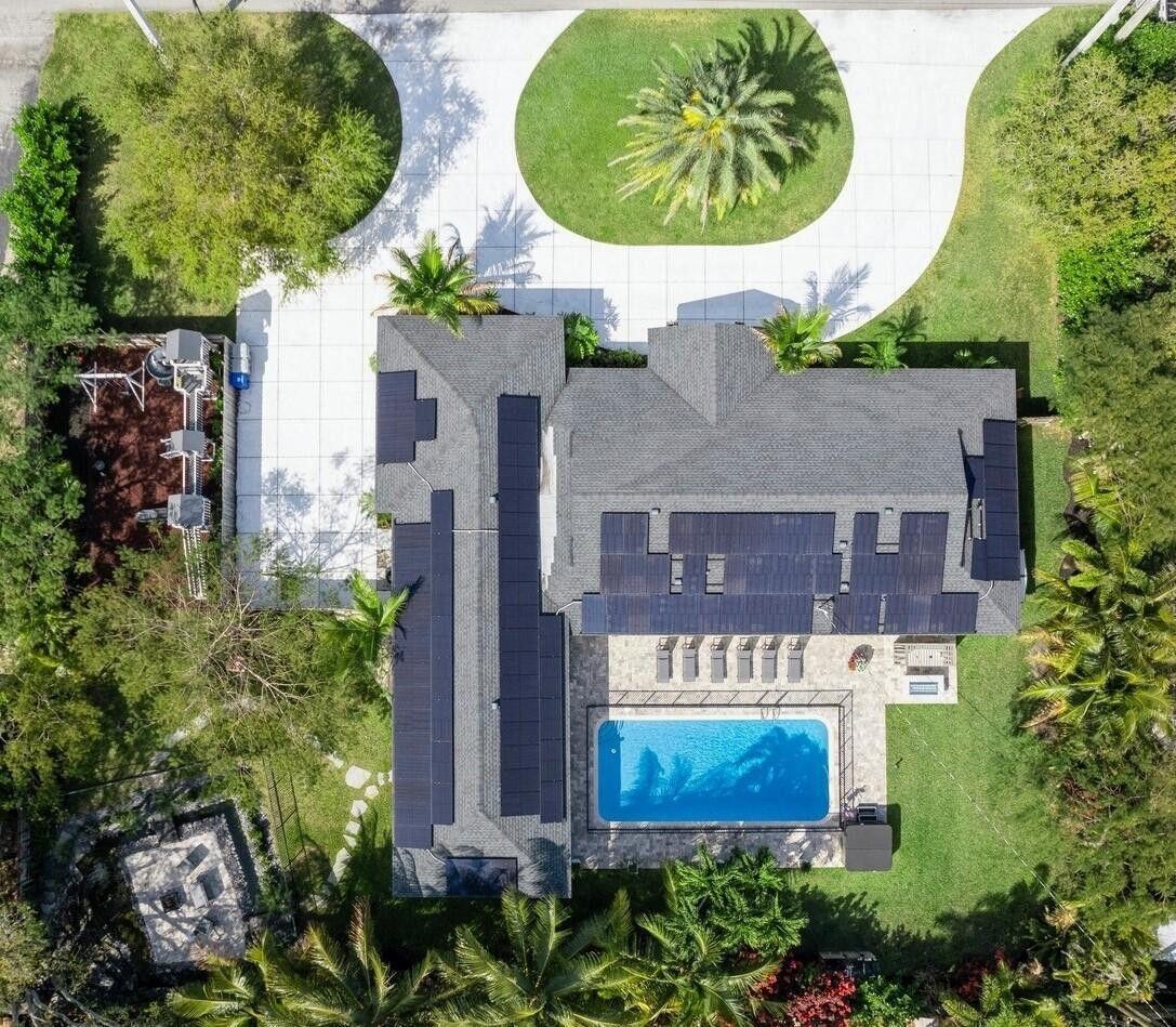Welcome to your dream oasis in highly sought-after Pompano Beach! No expense spared in this fully remodeled 5-bedroom, 3-bath gem sits on a lush 1/2-acre lot just minutes from the ocean. Impact windows and doors, solar panels, and a sprinkler system fed by a private well. Step inside to a bright, open floor plan with seamless flow to a stylish cabana bath and outdoor shower--perfect for indoor-outdoor living. Relax in the heated pool, cook in the outdoor kitchen with granite counters, or enjoy the tranquility of a Koi Pond with a moat and waterfall. A commercial-grade playground adds fun for all ages. This home blends luxury, comfort, and modern flair--your perfect Florida lifestyle awaits! Pompano is growing! With many projects underway it makes for a great place to live as well as an inv