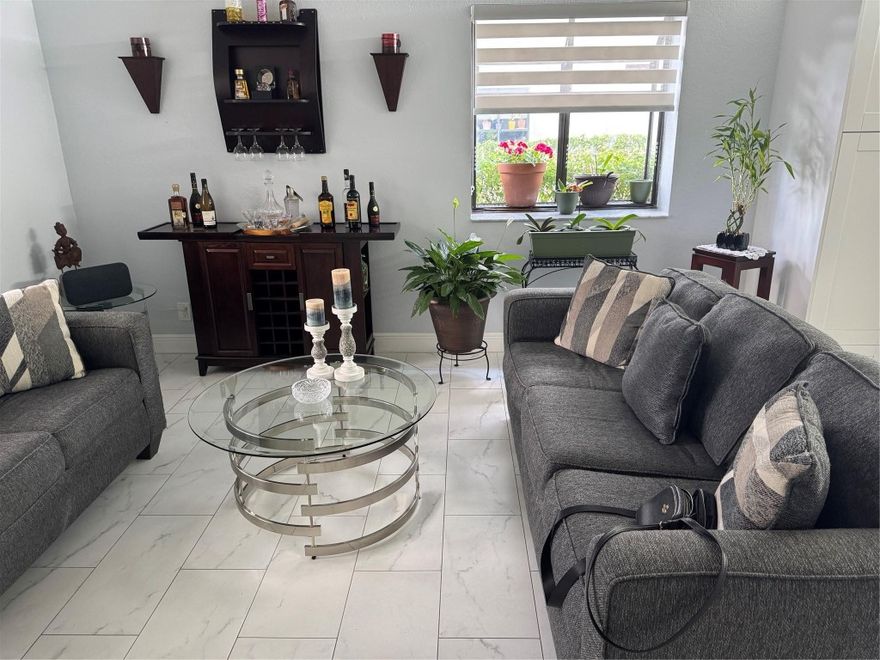 ALL AGES , Huge 1st-floor corner unit with nearly 1,500 sq ft in the gated community of Bonaire at Woodmont! Fully renovated kitchen and bathrooms. Brand new A/C and water heater. The den can be converted to a 3rd bedroom. Enjoy a private front entry with a screened porch and an oversized walk-out screened patio, just steps from the community pool. Spacious master suite features two walk-in closets and a vanity dressing area. Separate laundry/utility room with abundant storage. The large kitchen opens to a bright family room/den with a charming garden window. Small pets allowed. No leasing permitted.