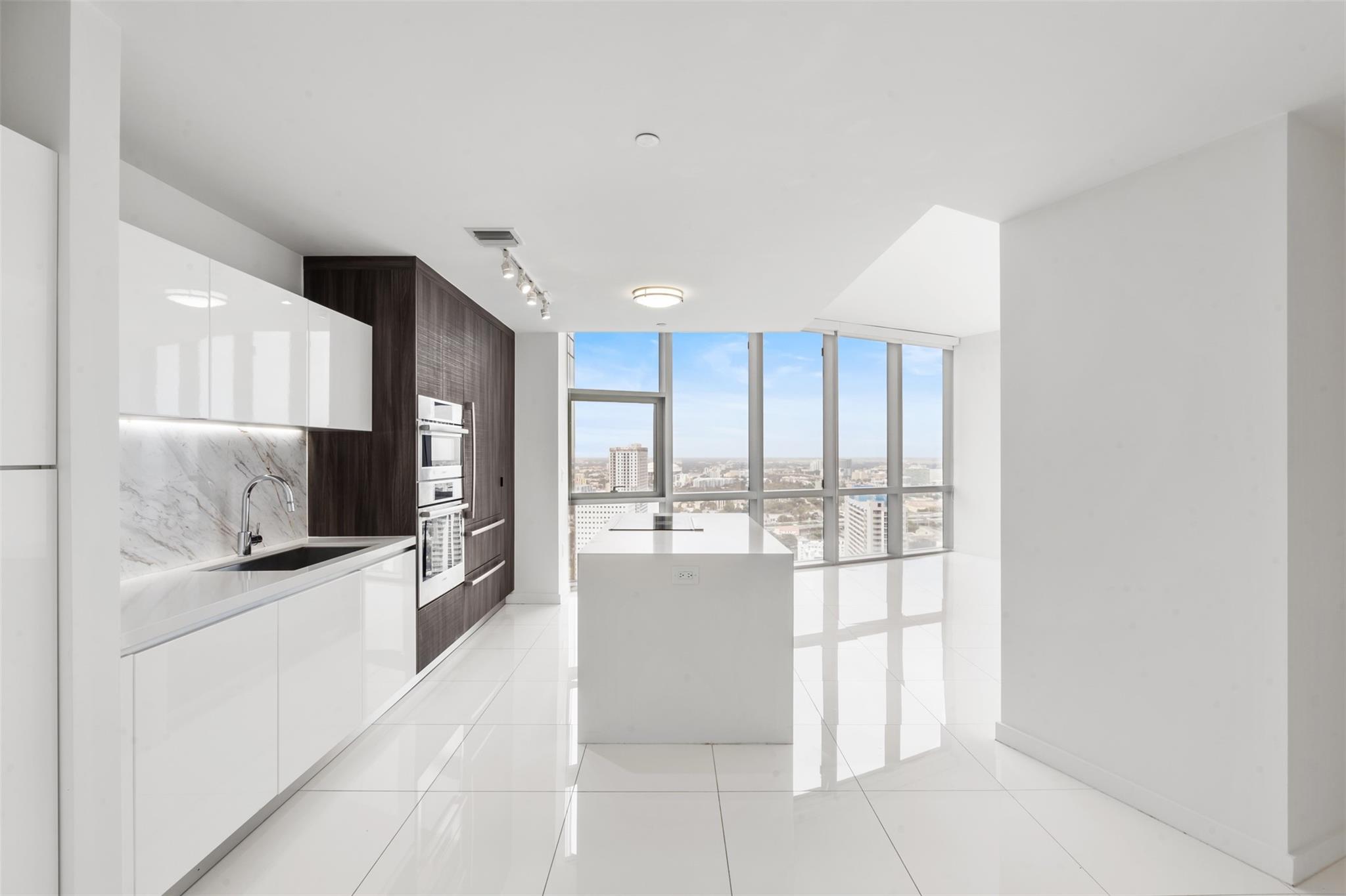 LUXURY 1 Bed + DEN / 1.5 Bath at PARAMOUNT MIAMI WORLD CENTER! This stunning unit offers a private elevator, white ceramic floors, oversized balcony with beautiful sunset views, built-out closets, and blinds on all windows. Includes 2 parking spots (1 valet & 1 assigned), internet, and cable. Located steps from Virgin Train Station, American Airlines Arena, Bayside, museums, and more. Paramount Miami World Center boasts world-class amenities, including 5 pools, a spa, gym with boxing area, basketball court, virtual golf, racquetball, yoga studio, BBQ kitchen, soccer field, skydeck, observatory, tennis courts, and a 53rd-floor jacuzzi with panoramic city views. Ready to move in—don't miss out! Schedule your showing today!