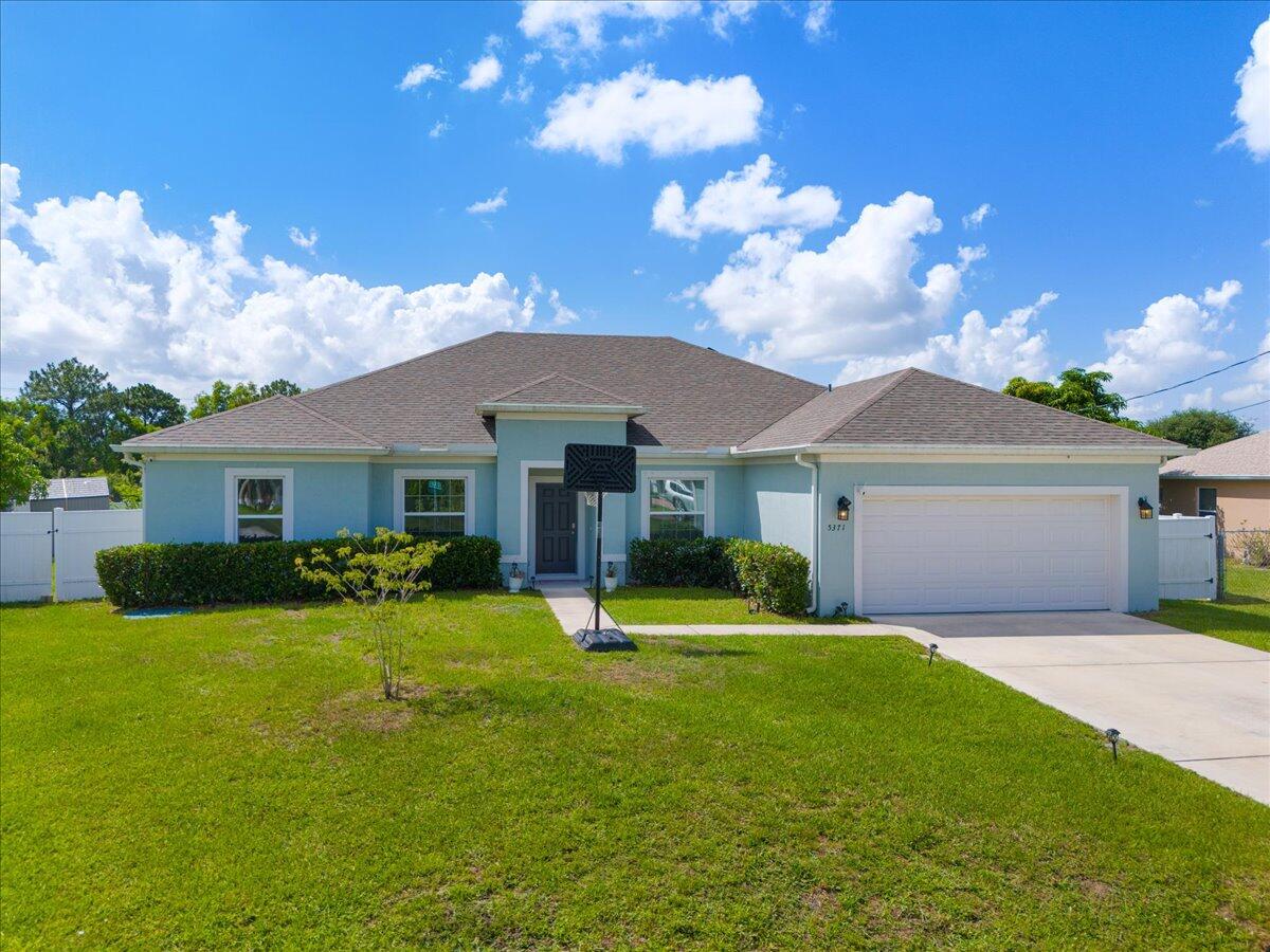 This 2022 features a 5BR/3BA/2CG floor plan with spacious patio offers privacy with no rear neighbors and great upgrades, including a long driveway, front porch entry, fenced yard, and shed. The open-concept layout features a large family room and coffered ceilings in both the dining area and owner's suite. The owner's suite includes a tiled shower and dual sinks. One of the bathrooms is a cabana bath, ideal for outdoor access. Vinyl plank flooring throughout (carpet in bedrooms) and upgraded baseboards. The kitchen showcases upgraded cabinetry with crown molding, quartz countertops, stainless steel appliances, pendant lighting, and a versatile dining nook that can double as a workspace. Close to schools, hospitals, and shopping.