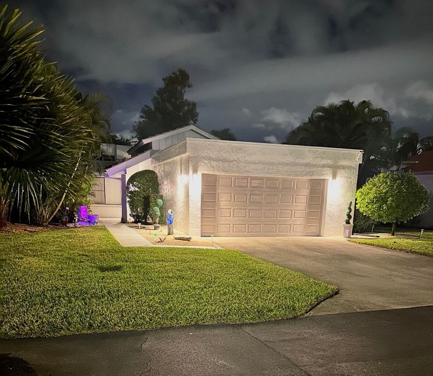 Fully renovated and thoughtfully upgraded, this move-in ready residence offers the rare combination of style, security, and peace of mind in one of Indian Spring's most desirable 55+ communities. The home is fully protected with accordion hurricane shutters and a new hurricane-impact garage door with updated motor and rails, while major systems have been addressed with a resurfaced flat roof in 2026, a tile roof from 2013, a 2025 Lennox A/C system, a 2023 water heater, and a 2022 washer and dryer. A newer electrical panel, all newer kitchen appliances, fresh interior and exterior paint, a sealed driveway, and finished garage flooring further enhance both function and presentation. Inside, the home unfolds into a bright, open living space where vaulted ceilings and  wide-plank flooring create an inviting sense of scale and warmth. The kitchen has been tastefully updated with modern finishes and newer appliances, designed to flow effortlessly into the main living and dining areas. Both bedrooms offer comfort and thoughtful design, each featuring walk-in closets with custom closet systems that make everyday living feel organized and effortless. The bathrooms have been beautifully renovated with clean, sophisticated finishes, creating a spa-like experience. Beyond the interiors, sliding glass doors lead to a private patio—an ideal setting for quiet mornings or relaxed evenings. Positioned along a series of peaceful cul-de-sacs that wind through the Indian Spring golf course, this home offers both privacy and a connection to the surrounding landscape. With a 24-hour manned gate and an optional country club for golf, tennis, dining, and social activities (membership is NOT mandatory), this is a home that delivers not only quality upgrades, but an elevated and flexible lifestyle.