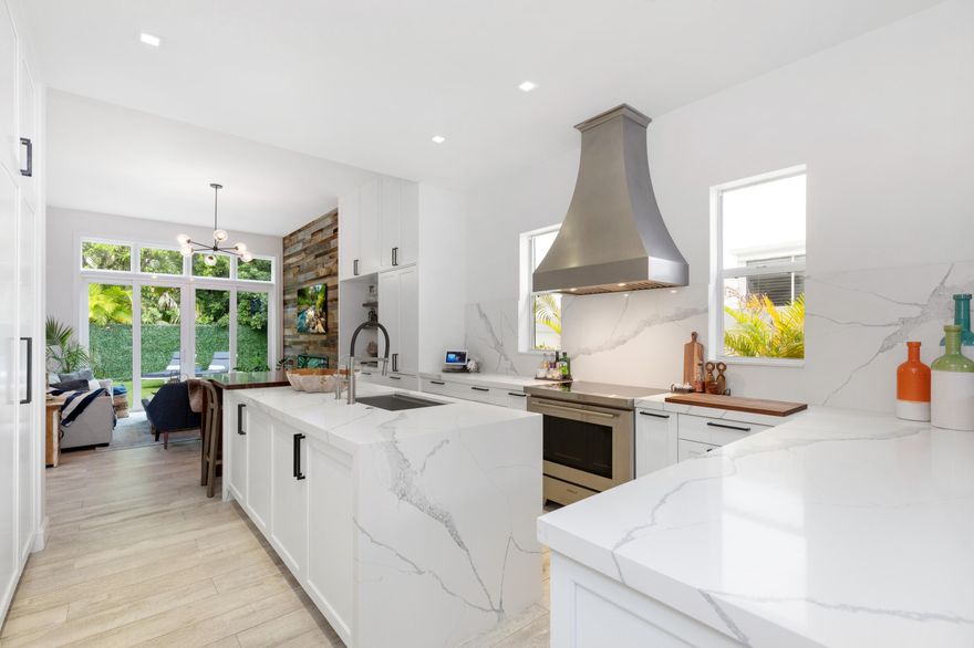 Experience island living at its best in this renovated 4,220SF estate within Grand Bay Estates, Key Biscayne's only guard-gated single-family enclave! This 5BR/5.5BA home features a 2021 roof, 2022 tankless water heaters, 2025 HVAC and full storm protection. The chef's kitchen shines with Quartz counters & Sub-Zero, Wolf, & Miele appliances, plus a dual-zone Sub-Zero wine fridge. The versatile layout includes all en-suite bedrooms, staff quarters, & a private in-law suite with its own entrance. Modern essentials include a climate controlled 2-car garage plus golf cart garage. The backyard oasis offers a heated saltwater pool, summer kitchen & retractable awnings, perfect for entertaining! HOA covers lawn care, 24hr security, pool maintenance, pest control, plus private park & playground! For the ultimate experience in luxury and privacy, look no further!