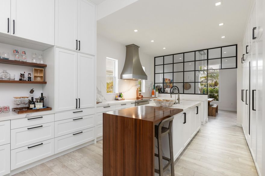 Experience island living at its best in this renovated 4,220SF estate within Grand Bay Estates, Key Biscayne's only guard-gated single-family enclave! This 5BR/5.5BA home features a 2021 roof, new tankless water heaters, new AC units and full storm protection! The kitchen shines with Quartz counters & Sub-Zero, Wolf, & Miele appliances, plus a dual-zone Sub-Zero wine fridge. The versatile layout includes all en-suite bedrooms, staff quarters, & private in-law suite with its own entrance. A rare find for Key Biscayne is the climate controlled 2-car garage plus golf cart garage. The backyard oasis offers a heated saltwater pool, summer kitchen & retractable awnings, perfect for entertaining! HOA covers lawn care, 24hr security, pool maintenance, pest control, plus private park & playground! For the ultimate experience in luxury and privacy, look no further!