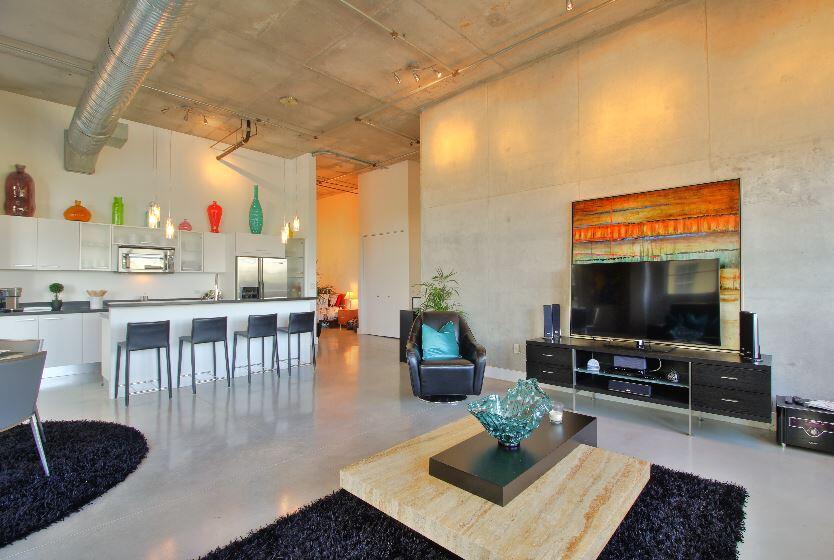 Experience authentic loft living at Avenue Lofts in Fort Lauderdale's vibrant Flagler Village. This stunning 3rd-floor unit boasts 20-foot ceilings, polished concrete floors, and exposed ductwork, creating a true industrial-chic aesthetic. Enjoy two full bedrooms, two baths, and a large private balcony perfect for relaxing. The building offers exceptional amenities, including a heated rooftop pool, a state-of-the-art gym, a club room, and a secure parking garage. Just steps from FAT Village and minutes from Las Olas, Brightline, and the beach. A pet-friendly, urban oasis in a prime location.