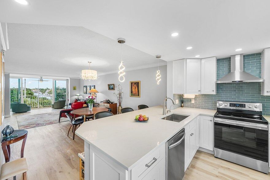 THIS HAS IT ALL! WOW FACTORS AT EVERY TURN-LONG CANAL VIEW TO THE INTRACOASTAL-MODEL PERFECT RENOVATION-HIGH IMPACT WINDOWS & DOORS-LUXURY LIFEPROOF VINYL OAK PLANK TILE FLOORING THROUGH OUT-OPEN KITCHEN W/QUARTZ COUNTERS-STAINLESS STEEL APPLIANCES-WASHER & DRYER-CONTEMPORARY DESIGNER LIGHTING-SPA CALMING SENSATION BATHS INCLUDES LED DEFOGGER MIRRORS, GLASS SLIDING SHOWER BARN DOORS, BENCH SEATING, & NICHES-WALK IN CLOSETS. EVERYDAY IS RESORT STYLE LIVING WITH HARBOR SIDE SALTWATER HEATED POOLS-CLUBHOUSE & BOATHOUSE-BILLIARDS-9 HOLE PUTTING GREEN/SHUFFLE BOARD-BOATING/FISHING-ACTIVE SOCIAL CALENDAR-CARD & BOOK CLUBS-GYM-GOLF & YACHT CLUBS. 'BRING YOU BOAT'! LOCATION LOCATION NEAR EVERY CONVENIENCE + 1.2 MILES TO THE VOTED #1 BEACH IN FLORIDA.