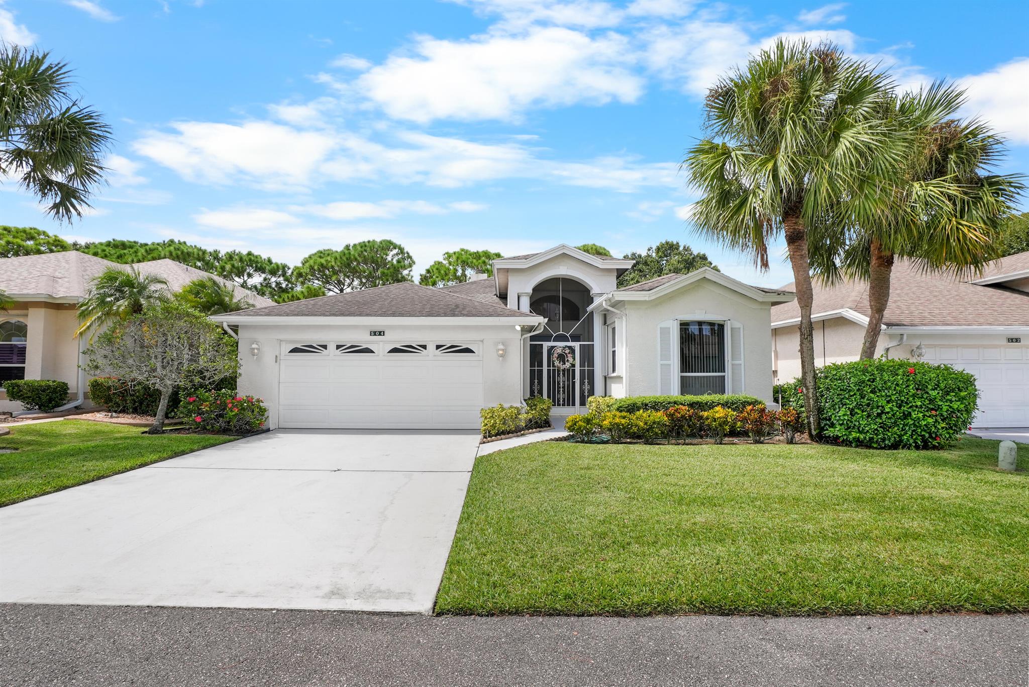 Spacious 2 bed / 2 bath + den home with 2,014 square feet in the desirable gated 55+ community of Kings Isle. Built with concrete block construction (CBS), this home offers peace of mind with accordion hurricane shutters, gutters, and 2016 A/C. Inside, enjoy vaulted ceilings, a fireplace, granite countertops, and a large primary suite with a massive walk-in closet. Relax outdoors on the screened front porch & screened patio with an awning. Includes a 2-car garage for plenty of storage. Kings Isle features resort-style amenities--pool, tennis courts, clubhouse, and activities--all in the heart of St. Lucie West near shops and dining.