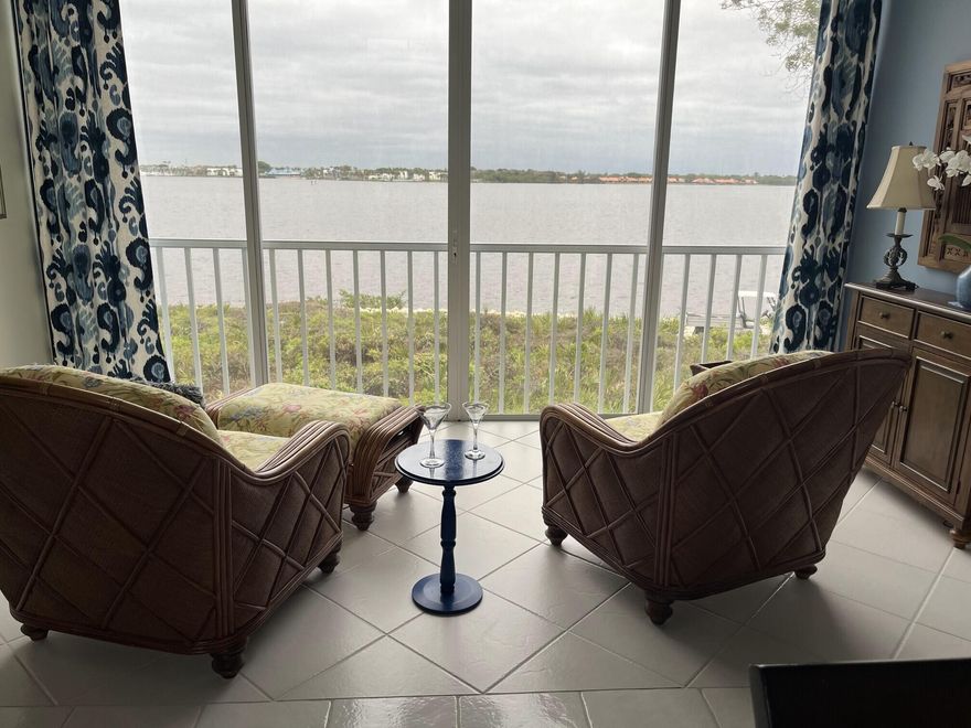 LOCATION, LOCATION, LOCATION!!!!  Enjoy stunning unobstructed river views of the St Lucie River from the Living Room, Kitchen, Master Bedroom and YES -waterfront dining! This 2nd floor 2-bedroom, 2-bath condo has high cathedral ceiling providing fabulous light. Includes a one-car garage and golf cart garage with work area. Furnishings are negotiable. Upgrades done since owners purchased include painting throughout, new shower in Master Bath, new washer & dryer, new refrigerator, added kitchen sink disposal, new stove in 2026, new carpet in both bedrooms. Enclosed patio, storm panels, A/C and H2O heater in 2021, ultraviolet air filter on A/C, pantry in kitchen, plantation shutters, Toto 'washlet' Toilet in Master Bedroom. PROFESSIONAL PHOTOS COMING SOON!