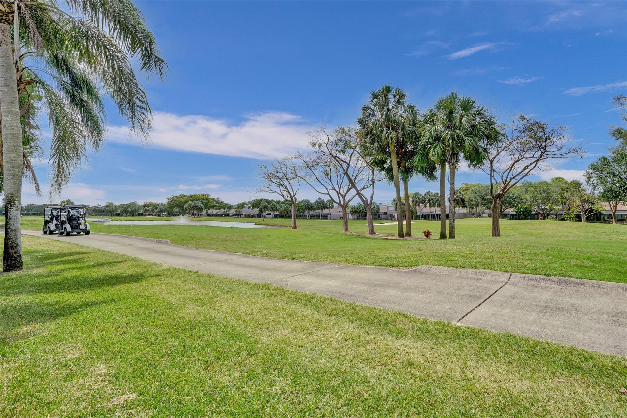 Incredible Golf Course views! This is a great opportunity to live on the golf course. This split level home has soaring high ceilings that make this unit feel grand and open. Large living area open to screened porch where you can sit and enjoy the lifestyle S Fla offers. Updated kitchens with stone counters and white timeless cabinets. The kitchen opens nicely into the living and dining area, No closed off kitchens here. Both Bathrooms have been tastefully remodeled with high end finishes. Storm shutters for all windows and doors. Great storage space. 2 assigned parking. Great community with pool. tennis, pickle ball. Low maint fee of $125/month. This home has it all !