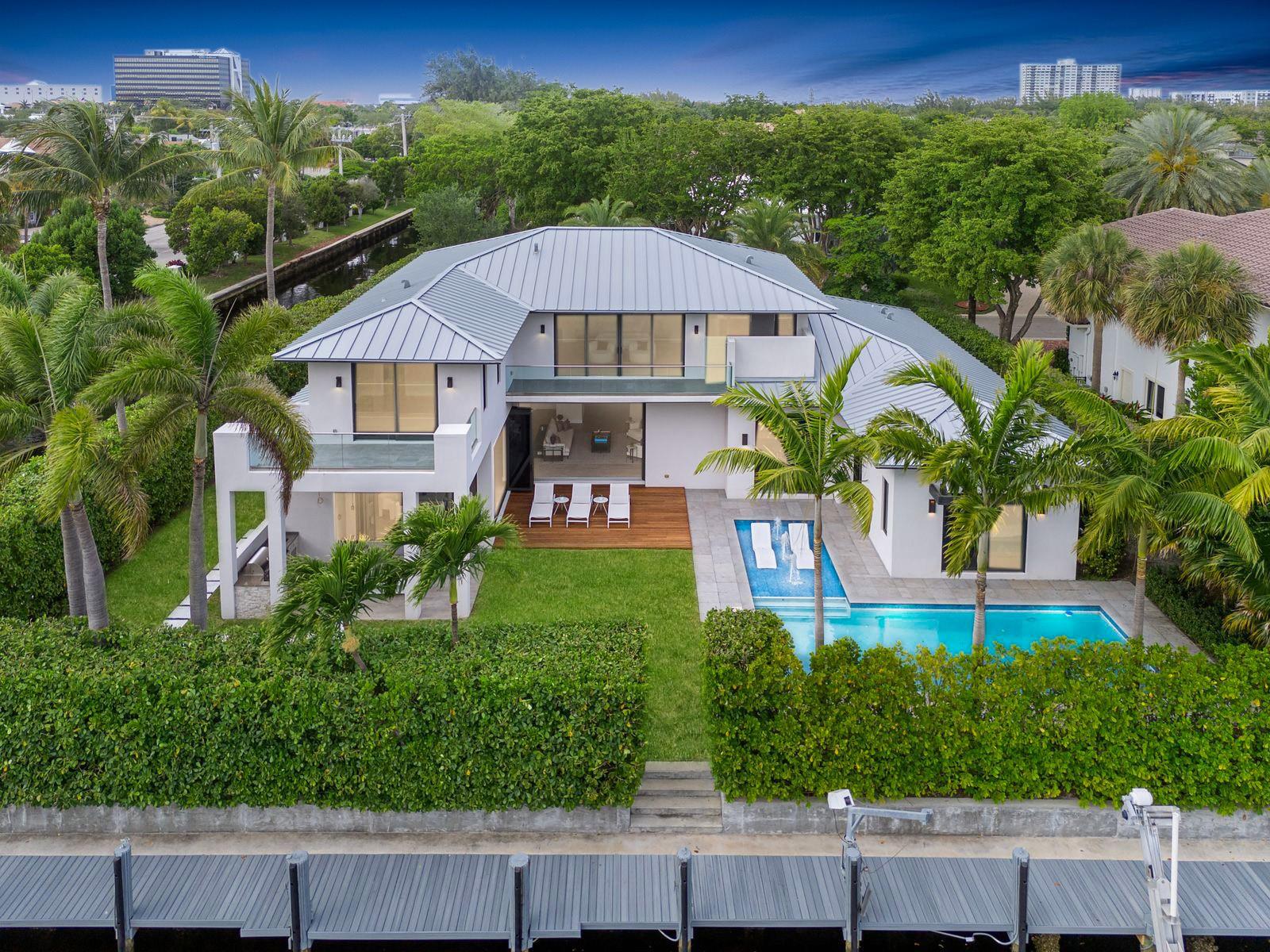Own this elite newly constructed waterfront estate in BAY COLONY completed in 2023, offering ultimate elegance in Fort Lauderdale’s most prestigious gated community. Featuring a modern gourmet kitchen, home theater & private office. Living spaces are filled with natural light due to the South facing design. With unique details such as collapsing nano doors leading to the summer kitchen, entertaining spaces seamlessly flow from inside to outdoors. Nestled on an interior-facing point lot with 310ft of water frontage, ideal for multiple vessels. The garage accommodates up to 6 cars with lifts installed. Conveniently located near Pine Crest School, Coral Ridge CC, executive airport & the beach, this estate emanates an unmatched lifestyle. 24/7 armed security. Seller Financing Available.