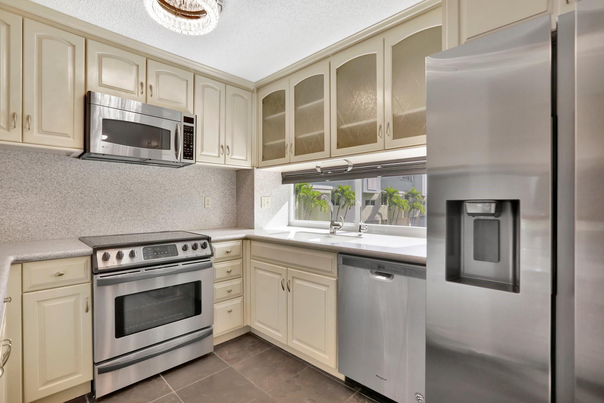 WELCOME HOME! Rarely available corner townhome with a garage and fully fenced yard. This boutique gem of a community is situated on a quiet street between the intracoastal and the beach. Beach access just around the corner. This townhome is breathtaking featuring high ceilings, custom flooring, tons of cabinets and storage, finished garage with Tesla charging station, newer appliances, full impact windows and doors, hardwood flooring, laundry room and so much more. Community heated pool and 1 assigned parking spot in addition to the garage. You will fall in love with the architecture and large rooms. See today!