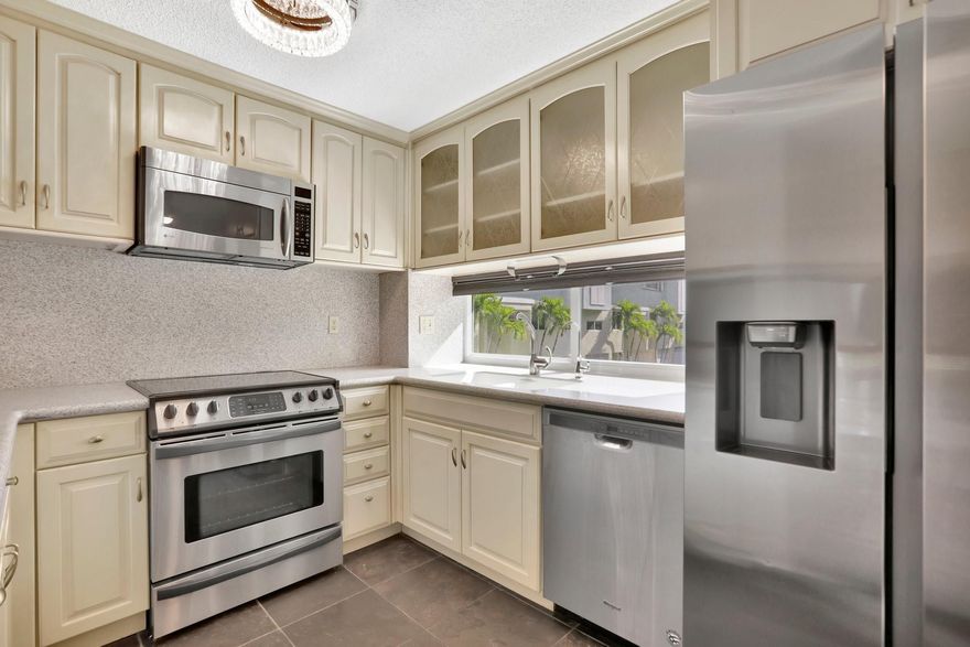WELCOME HOME! Rarely available corner townhome with a garage and fully fenced yard. This boutique gem of a community is situated on a quiet street between the intracoastal and the beach. Beach access just around the corner. This townhome is breathtaking featuring high ceilings, custom flooring, tons of cabinets and storage, finished garage with Tesla charging station, newer appliances, full impact windows and doors, hardwood flooring, laundry room and so much more. Community heated pool and 1 assigned parking spot in addition to the garage. You will fall in love with the architecture and large rooms. See today!