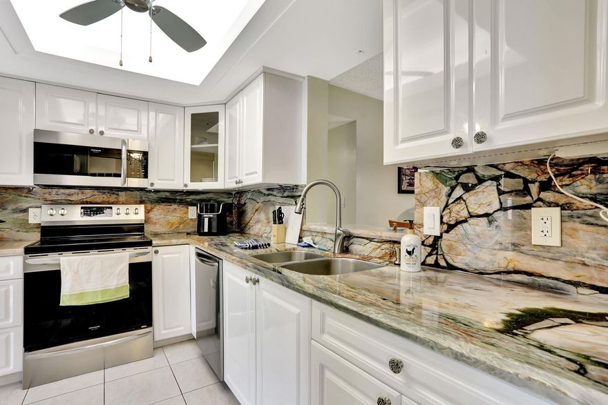 Beautifully renovated first-floor 2 bed, 2 bath condo in a quiet, well-maintained  community. Features include a fully updated kitchen with Brazilian Michelangelo quartzite countertops, modern cabinetry, and newer appliances. New A/C system, accordion hurricane shutters,  impact-resistant windows and sliding door provide peace of mind and natural light. Full-size washer/dryer in unit, private storage room, and plenty of guest parking. Enjoy tranquil golf course views from your living space. Conveniently located near shopping, dining, and major highways. Move-in ready!