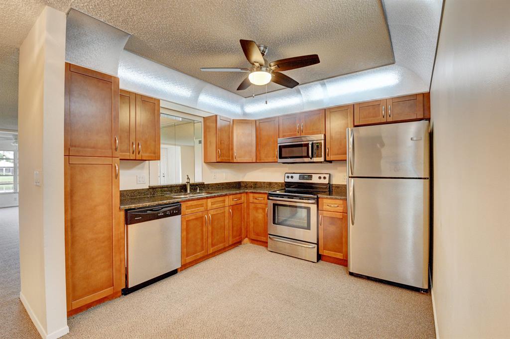 Single-floor villa in 55+ community. Waterfront (lake) 2/2 with cover/screened large patio, private garage/driveway. Lovely 1,227 feet living space (under air), newer kitchen with all granite and real wood, newer matching SS appliances, washer and dryer, carpet (except bathrooms) for safer living, and newer hot water heater (2020). Driveway newly repainted (2020). Nearby restaurants, post office, pharmacy, specialty food shopping and within 5 miles of Delray Marketplace. Close to 441 and Florida Turnpike. Western exposure for beautiful sunsets and birdwatching. Front of villa faces east. Shutter panels for new owner's hurricane protection. Private clubhouse with active clubs, games, exercise room, large swimming pool with aquatic classes. On-site property manager. Low HOA $265/mo.