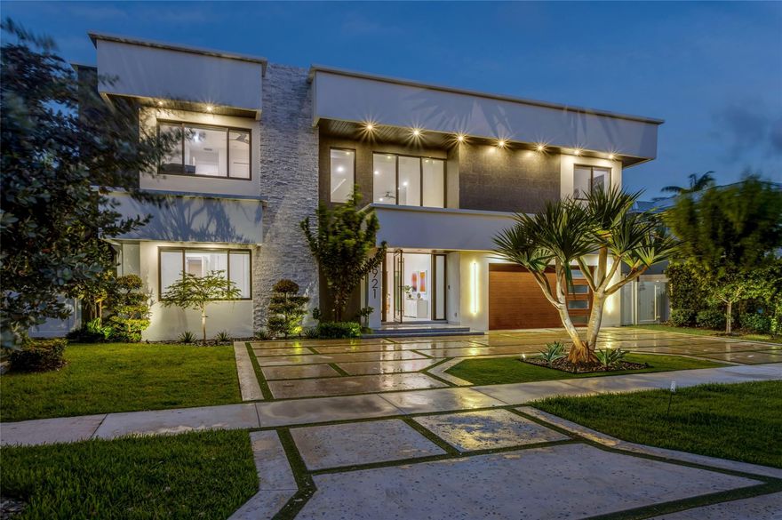 Chic, Modern Deepwater Estate in sought-after Lighthouse Point sited on 80’ of waterfrontage minutes to the Hillsboro Inlet. This remarkable five-bedroom, five-bath, two-half-bath residence offers 4,683± living square feet in a sophisticated modern design. Impressive double-height foyer with light-filled interiors and window walls of glass. Chef’s island kitchen with luxe appliances. 1st-level primary suite features water views, spa-like bath, & fully outfitted walk-in closets. Amenities include Control4 automation, Sonos sound system, electric shades, impact windows/doors, and 2-bay garage. Outdoor entertainment is enjoyed at the resort-style heated pool with spill-over spa and expansive covered loggia with motorized screens. Avid boaters will enjoy the full-service composite yacht dock.