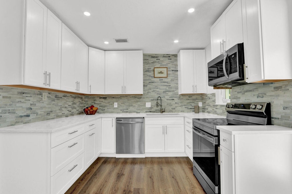 Photo of 222 Bayberry Drive, Lake Park, FL 33403 (MLS # B26042419)