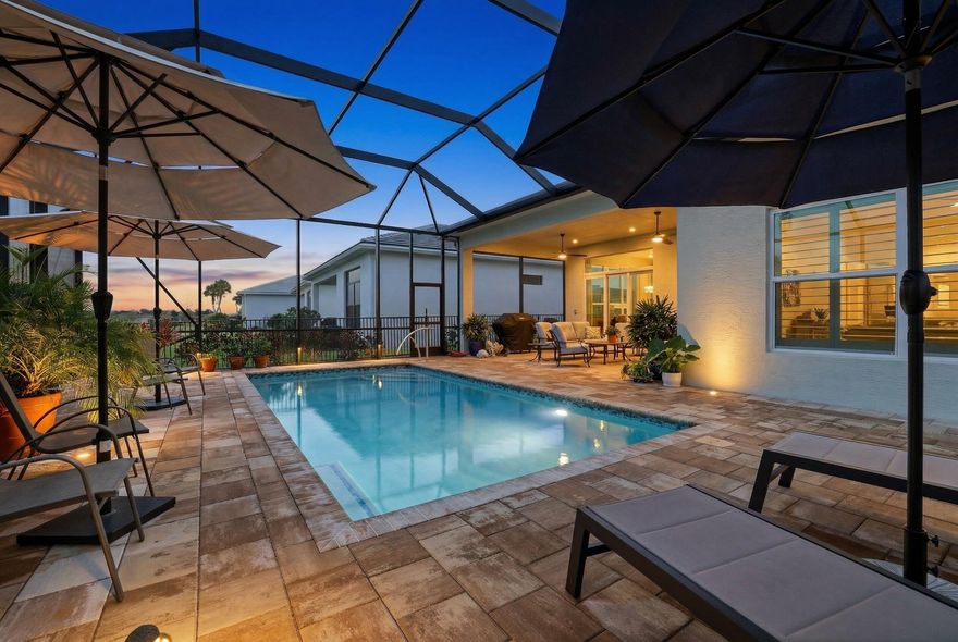 PRICE IMPROVEMENT on this spectacular pool home!  A rare opportunity to own a fully upgraded pool home at this price point in PGA Verano.  This stunning Grace model offers 3 bedrooms, 2 baths, and 1,910 sf of beautifully designed living space.  Featuring a coastal elevation with an inviting front porch, chef's kitchen with upgraded Cafe appliances and double oven, soaring ceilings with designer finishes, and abundant natural light throughout.  The extended owner's suite and lanai create a seamless indoor-outdoor lifestyle overlooking a heated screened pool and fenced backyard.  Every detail has been thoughtfully upgraded.  Please view the list of upgrades in the documents tab.  This home shows like a model and is move-in ready! Welcome to the beautifully appointed Grace model in the highly sought-after community of PGA Verano.  This thoughtfully designed 3-bedroom, 2-bath home combines elegant design, functional living spaces, and exceptional outdoor enjoyment.    From the moment you arrive, the home's coastal elevation and inviting front porch creates outstanding curb appeal, enhanced by lush, tropical landscaping that reflects true pride of ownership.  Step inside and immediately notice the abundance of natural light, soaring ceilings, and open concept layout that make this home feel bright, spacious, and welcoming.    The main living area showcases 11'4" ceilings in the great room, kitchen, and primary suite, with a tray ceiling accented with beautiful wood beams, adding warmth and architectural interest to the space. The chef's kitchen is designed for both everyday living and entertaining, featuring upgraded GE Cafe appliances, a double wall oven, generous cabinetry, and a seamless flow into the dining and great room areas.  The open concept layout allows for effortless entertaining while maintaining a comfortable and functional living environment. One of the most desirable features of the Grace floor plan is the private entry to the primary suite, creating a peaceful retreat separate from the guest bedrooms.  The spacious primary bedroom, with its 4' extension, also features a tray ceiling and overlooks the tranquil backyard setting. Additional interior highlights include a fully equipped laundry room with built-in cabinetry and sink, providing excellent storage and convenience, a full house water system with additional reverse osmosis under kitchen sink, plantation shutters, lighting fixtures and ceiling fans.  Step outside to your extended covered lanai and private backyard oasis, where a 12 x 24' heated pool is enclosed within a screened enclosure.  Beyond the screened lanai, the fenced backyard offers additional privacy, creating the perfect setting for relaxing, entertaining, or enjoying Florida's beautiful weather year-round.  Located within the award-winning PGA Verano lifestyle community, residents enjoy an exceptional array of amenities designed for an active and social lifestyle.  The community features over 100 clubs to join, 27 pickleball courts with a vibrant pickleball community, five Har-Tru clay tennis courts, and three pools, including a resort pool, indoor lap pool, and resistance pool. Fitness enthusiasts will appreciate the two fitness centers, including the impressive E-Gym fitness facility, while outdoor lovers can enjoy miles of beautifully maintained walking and biking trails throughout the community.  PGA Verano is also a golf cart friendly community within two manned guard gates, providing both convenience and peace of mind. This exceptional home truly offers the perfect blend of comfort, style, privacy, and resort-style living in one of Port St. Lucie's most desirable communities.