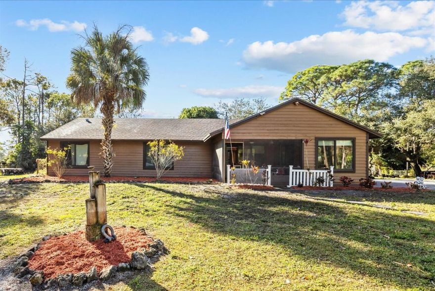 Spacious 4BR/2BA custom cedar home on nearly 2 acres in desirable Loxahatchee. Enjoy peaceful country living with great neighbors and no HOA! Features include a circular driveway, fully fenced yard with 3 gated entrances, new roof, new impact low windows/sliders, remodeled master shower, newer AC, and freshly painted bedrooms. An open floor plan offers bright, inviting living spaces filled with natural light. Outdoor features includes wraparound sidewalk, above ground pool, large fire pit, and fruit trees (mango, banana, coconut) surrounded by palm and pine trees for added privacy. Plenty of space for RV parking, farm animals, and future expansions, this home offers endless possibilities. Quiet, private, and thoughtfully updated, it's exactly what you've been looking for—and again-NO HOA!